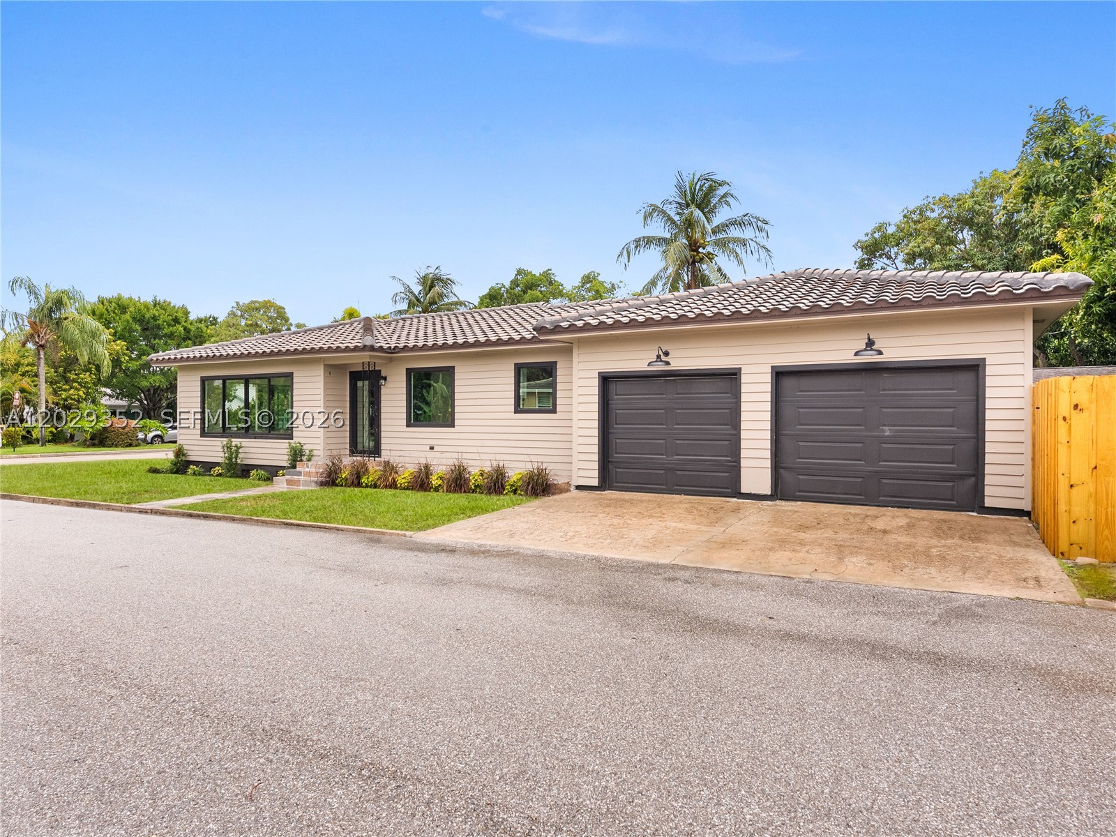 Welcome to this exceptional 3-bedroom, 3-bathroom residence located in the highly sought-after South Palmway neighborhood of Lake Worth Beach, just one block from the Intracoastal Waterway. Situated on a desirable corner lot, this beautifully renovated home offers a rare combination of modern luxury, timeless charm & a two-car garage, a true rarity in this historic coastal community.  Completely renovated with permits, this turnkey property has been redesigned from top to bottom with quality craftsmanship. Major improvements include a brand-new roof, hurricane-impact windows & doors offering insurance savings, electrical panel & wiring, new HVAC & ductwork, updated plumbing, new drywall, & new flooring throughout.  The  chef's kitchen features professional-series appliances, custom cabinetry, elegant quartz countertops & a functional layout designed for both everyday living and entertaining. All three bathrooms have been tastefully updated with designer finishes, including new vanities, modern fixtures, and beautifully appointed showers. Additional upgrades include a new water heater, irrigation system, fencing, and fresh professional landscaping. The oversized corner lot provides ample space to create your dream backyard oasis, with plenty of room for a pool while still maintaining generous yard space for entertaining, gardening, or simply enjoying the South Florida lifestyle. No detail was overlooked! Come enjoy the best of Lake Worth Beach living.