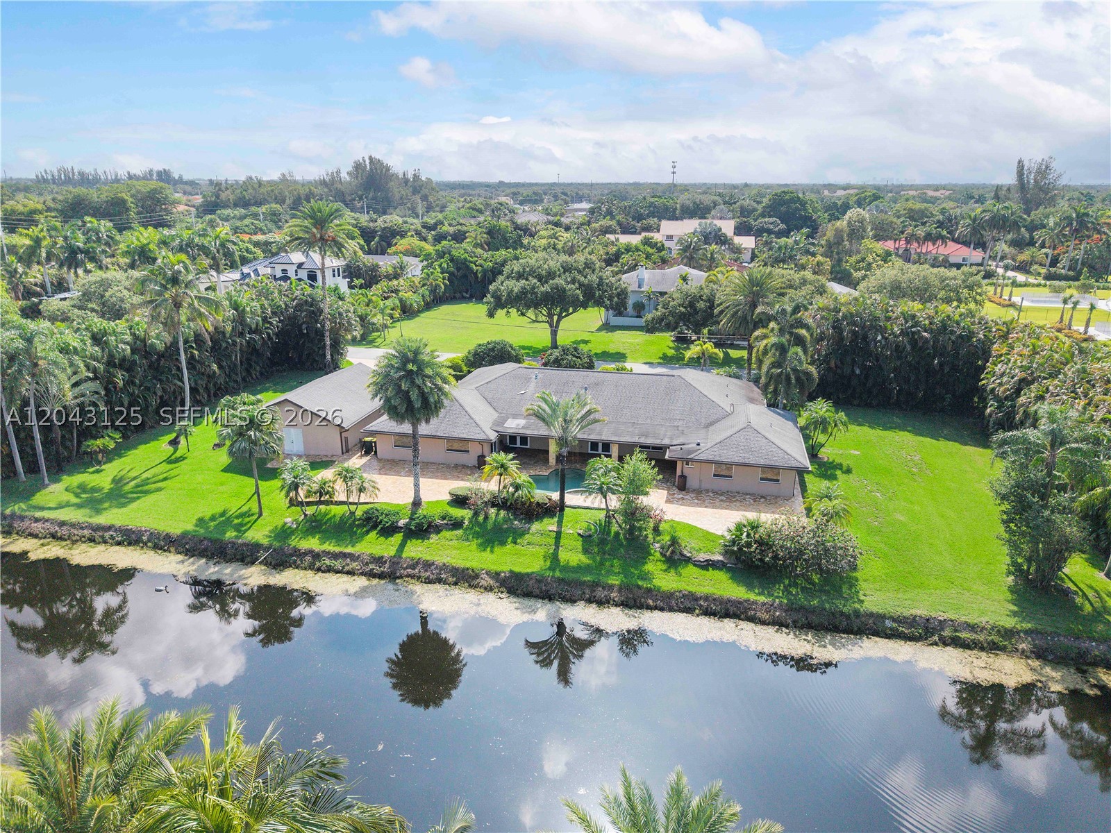 This exceptional 5-bedroom, 3-bathroom home offers an incredible amount of living space and flexibility to fit your lifestyle. Oversized living areas, spacious eat-in kitchen with 2 islands (cooking island and 10 person seating island), and generously sized bedrooms.
The expansive primary suite is a true retreat, featuring a private sitting area perfect for a home office, reading nook, or workout space. The luxurious primary bath includes a relaxing soaking tub and bidet for added comfort.
Need room for hobbies, vehicles, or a workshop? This property delivers with a 4-car garage, including a separate detached 2-car garage with dedicated workshop space as well as Impact windows and doors, whole home generator, bulit out closets, and removable pool fence.
Step outside to enjoy the large patio area overlooking a sparkling pool, all set against a wide, tranquil water view. Situated on almost an acre of land; there is plenty of room to spread out. This home offers the perfect combination of comfort, functionality, and outdoor living.
This is a rare opportunity to own a home that truly offers space to live, space to entertain, and space to grow. You have to see it in person to fully appreciate everything it has to offer!