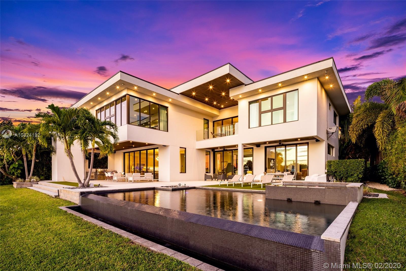 Modern Yachtmans Architectural Waterfront Paradise featuring jaw dropping sunset views and views of the downtown skyline, 23 foot ceilings, over 100 feet of deep wide water views and located in the prestigious Sunrise Intracoastal gated community. The open floor plan amplifies the view upon entry. The seamless indoor to outdoor living space makes perfect for entertaining. Porcelain and wood throughout, open gourmet kitchen with breakfast area. Wet bar, fireplace, high ceilings. Upstairs den features spacious terrace. Master suite overlooks the river. Outdoor built in summer kitchen overlooking sparkling pool + jacuzzi. Over 500 feet of open water views. No wake zone, direct ocean access. Walking distance to shopping mall, restaurants and the beach!
