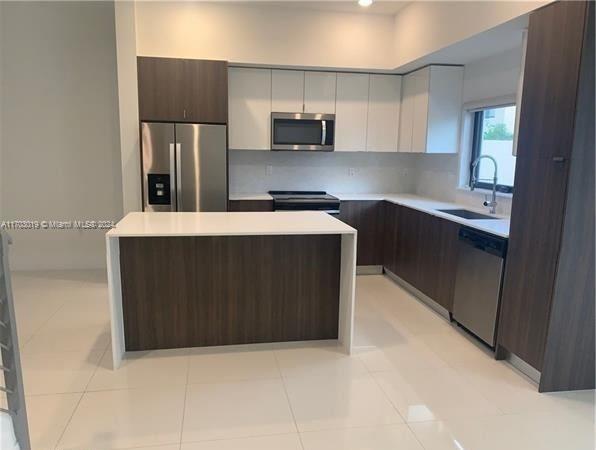 Beautiful townhome located in the heart of Kendall! This stunning property features a modern kitchen with stainless steel appliances, quartz countertops, and ample cabinetry. Enjoy porcelain floors, 2.5 bathrooms, and spacious bedrooms. The private master suite boasts a large walk-in closet and a luxurious bathroom with a walk-in shower and separate toilet area. Relax or entertain in the large patio. Nestled in a vibrant community, it’s just steps from Publix, Walgreens, top-rated schools, and popular restaurants—everything you need within walking distance!