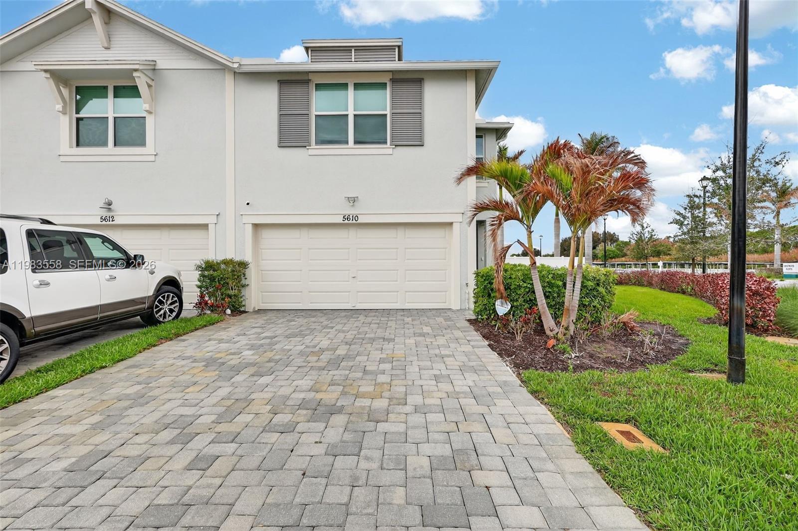 Experience elevated living in this beautifully upgraded 2024-built former model home, showcasing thoughtful design and premium features throughout. The modern kitchen impresses with crisp white cabinetry, upgraded countertops, a stylish backsplash, and premium Whirlpool appliances, seamlessly flowing into a bright living space enhanced by luxury vinyl flooring. Impact windows and doors offer added peace of mind, while the garage stands out with fully finished walls, sleek epoxy flooring, and an electric vehicle charger. Enjoy serene partial lake views and the convenience of an extended driveway. Priced to sell—this exceptional home won’t last long!