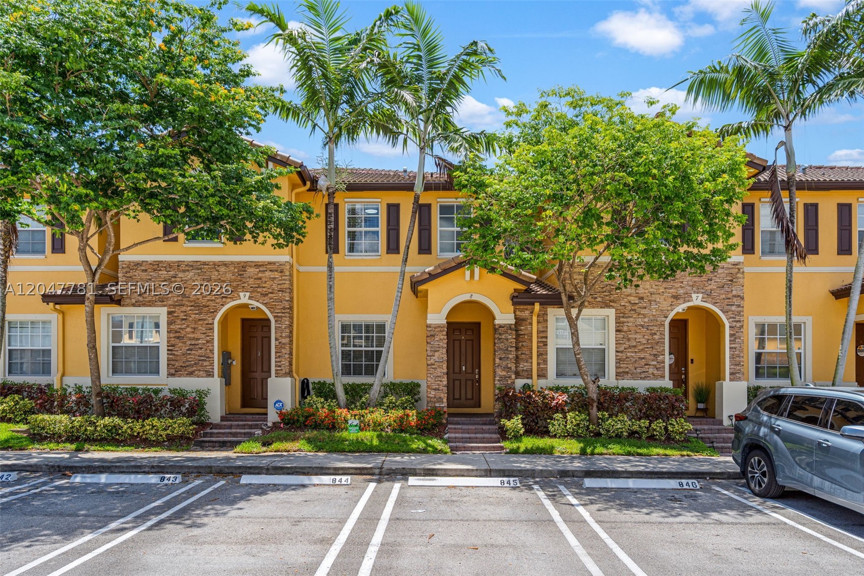 Welcome to this beautifully updated 2-bedroom, 2.5-bath townhome in the highly sought-after community of The Shores! This move-in ready home features tile flooring throughout, including matching porcelain tile on the staircase and entire second floor for a seamless, elegant look. The kitchen is equipped with one-year-old stainless steel appliances, while the washer and dryer are less than a year old. Additional upgrades include a newer A/C unit, a Titan tankless water heater, and professionally built-out closets in both bedrooms, providing exceptional storage and organization. Step outside to a fully fenced backyard, perfect for entertaining, pets, or enjoying your own private outdoor space. Residents of The Shores enjoy a gated community with resort-style amenities, including a clubhouse, swimming pool, fitness center, playground, and beautifully maintained common areas. Conveniently located near top-rated schools, shopping, dining, and major highways, this home offers the perfect combination of comfort, style, and convenience. Don't miss the opportunity to make this exceptional property your own!