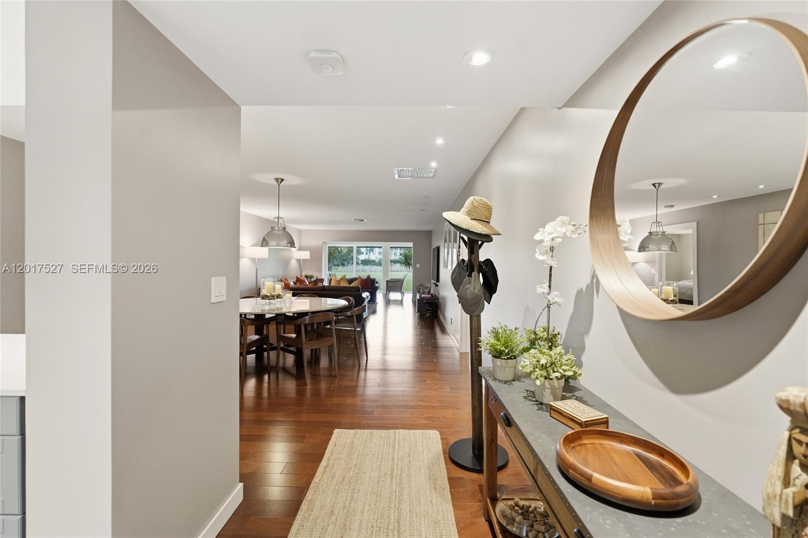 Rarely available Patio floor plan — one of the most coveted layouts in the community and seldom on the market. This gut-renovated residence was finished in 2017 and has been transformed top to bottom with designer finishes and nothing left to do.
Rich hardwood floors flow throughout the open great room, dining area, and expansive living room, all bathed in natural light from floor-to-ceiling sliding glass doors overlooking lush green views. The reimagined kitchen features custom grey shaker cabinetry, quartz countertops, glass-front uppers, stainless Samsung appliances, under-cabinet lighting, and a breakfast bar — a chef's kitchen that doesn't sacrifice style for function.
The primary suite is a true retreat, complete with plantation shutters, a spa-caliber bath with dual vanities, freestanding soaking tub, glass-enclosed rain shower, and a custom walk-in closet with full built-ins. Every detail was executed with intention — recessed lighting, designer fixtures, and a curated neutral palette throughout.
Properties at this level of finish in the Patio configuration simply don't come along often.