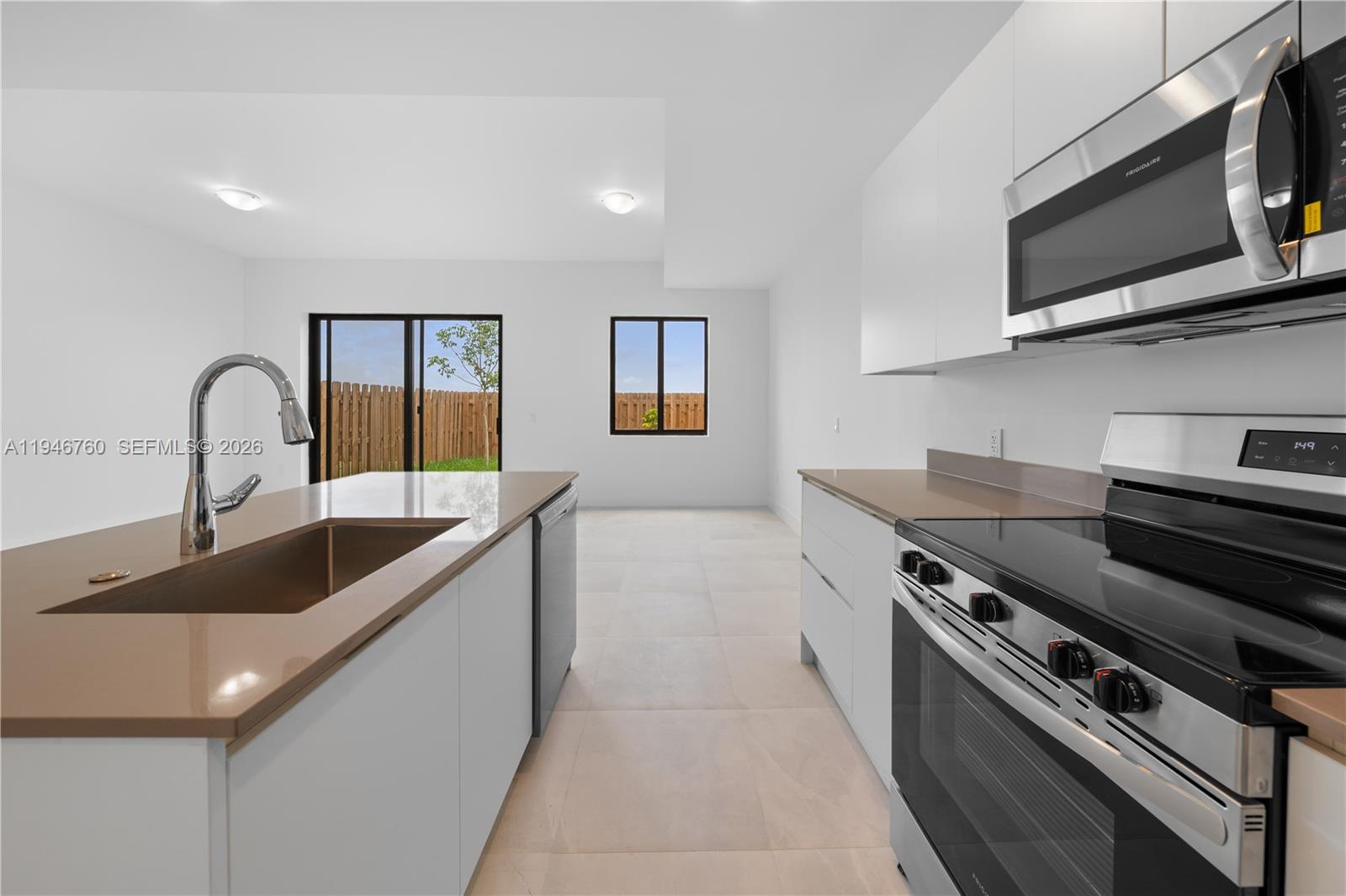Available now, brand new townhouse in Florida City.  Open-concept layout and no carpet: 3 bed / 2.5 bath. Tile downstairs and modern laminate upstairs, plus private backyard. Contemporary kitchen with clean lines and quality finishes. All impact windows. Rare parking setup for the price point: attached garage plus paver driveway for two vehicles. Motivated seller offering contribution toward buyer’s closing costs. Low HOA $101/month. Vacant and easy to show. No builder fee. Additional property available in the same community . MLS #: A11946727 | Price: $390,000.