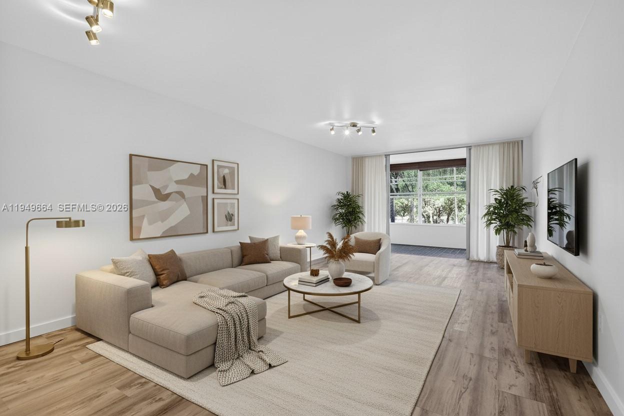 Bright, updated, and truly inviting—this 1-bedroom, 1.5-bath condo in Rolling Green stands out for its light, layout, and flexibility. Located on the second floor of an elevator building, the home features an amazing Florida room offering additional indoor-outdoor living space, seamlessly connecting to both the living room and bedroom and overlooking peaceful garden views. Impact Glass for peace of mind. The kitchen is finished with sleek, contemporary white cabinetry that complements the stainless steel appliances, while chic neutral tile, laminate flooring, and clean wall tones enhance the abundance of natural light throughout. Character-rich built-ins add both charm and functionality, paired with a walk-in closet and a beautifully updated bathroom with glass shower doors. Conveniently located just minutes from Aventura Mall, dining, shopping, parks, and easy access to I-95.