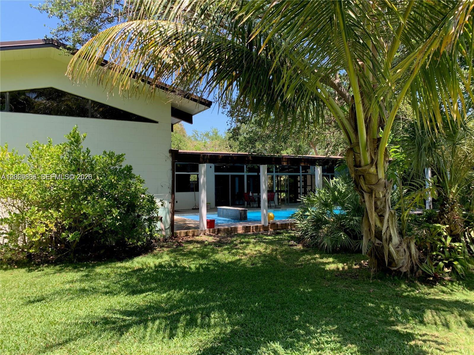 Rare opportunity to acquire a premier estate-sized parcel in one of Pinecrest’s most coveted enclaves. Spanning 38,768 SF (nearly one acre), this exceptional north-facing lot offers the highly sought-after southern rear exposure preferred by architects and luxury homebuilders for optimal natural light, outdoor living, and pool enjoyment throughout the year. Surrounded by newly constructed multi-million-dollar estates, the property presents an ideal canvas for a signature custom residence.

The existing 4-bedroom, 3.5-bath home with a 17' x 40' pool provides options for renovation, expansion, or redevelopment. Nestled on a quiet residential street with minimal through traffic, primarily serving neighborhood residents, this property offers a rare combination of privacy, prestige, and tranquility. Ideally located near top-rated schools, parks, fine dining, and premier shopping. 
Easy to show. Please text Marcelo Hallais at (786) 438-9410.