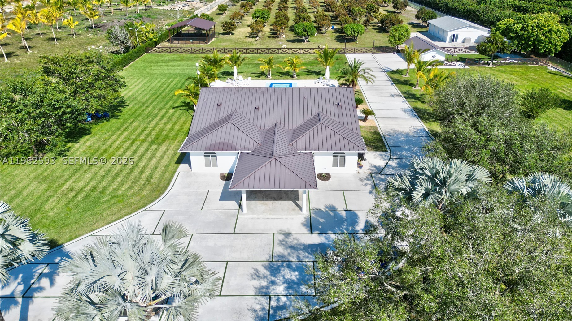 Virtually Staged. Welcome to your private slice of paradise in the Redland area of Miami. Situated on an expansive 4.79-acre lot (over 208,000 sq ft), this beautifully renovated estate blends luxury living with a serene countryside atmosphere.

The property features a 5-bedroom, 4-bathroom layout, including a separate 1-bedroom, 1-bath guest house—perfect for extended family, visitors, or rental potential. The main residence offers spacious interiors, modern upgrades, and hurricane-impact windows throughout for added safety and peace of mind.

Step outside to an entertainer’s dream: a 40x30 saltwater pool with whirlpool spa, surrounded by lush landscaping, mature fruit trees, and palm trees. The outdoor space is designed for gatherings, relaxation, and enjoying South Florida’s year-round sunshine.