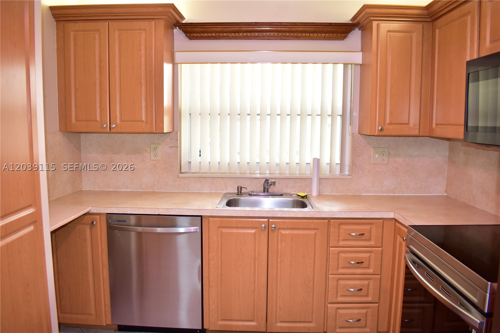 Important features for this unit include: *impact glass windows and doors, *handicap accessibility for one bathroom with short step-in shower and easy toilet support (see pics) and *a great location within the community! This large 2 bedroom unit also features *updated bathrooms, *kitchen with newer cabinets and stainless steel appliances.  *The floors are all ceramic tiles laid on the diagonal.  Outside, you realize you are within a very short distance to the main clubhouse and all the action plus the community golf course (free!).  Use any one of the 10 swimming pools available to you (even chlorine free, salt water pools), the pickleball courts, tennis, the gym, the theater, bocce-ball court and many new good friends to share good times with.