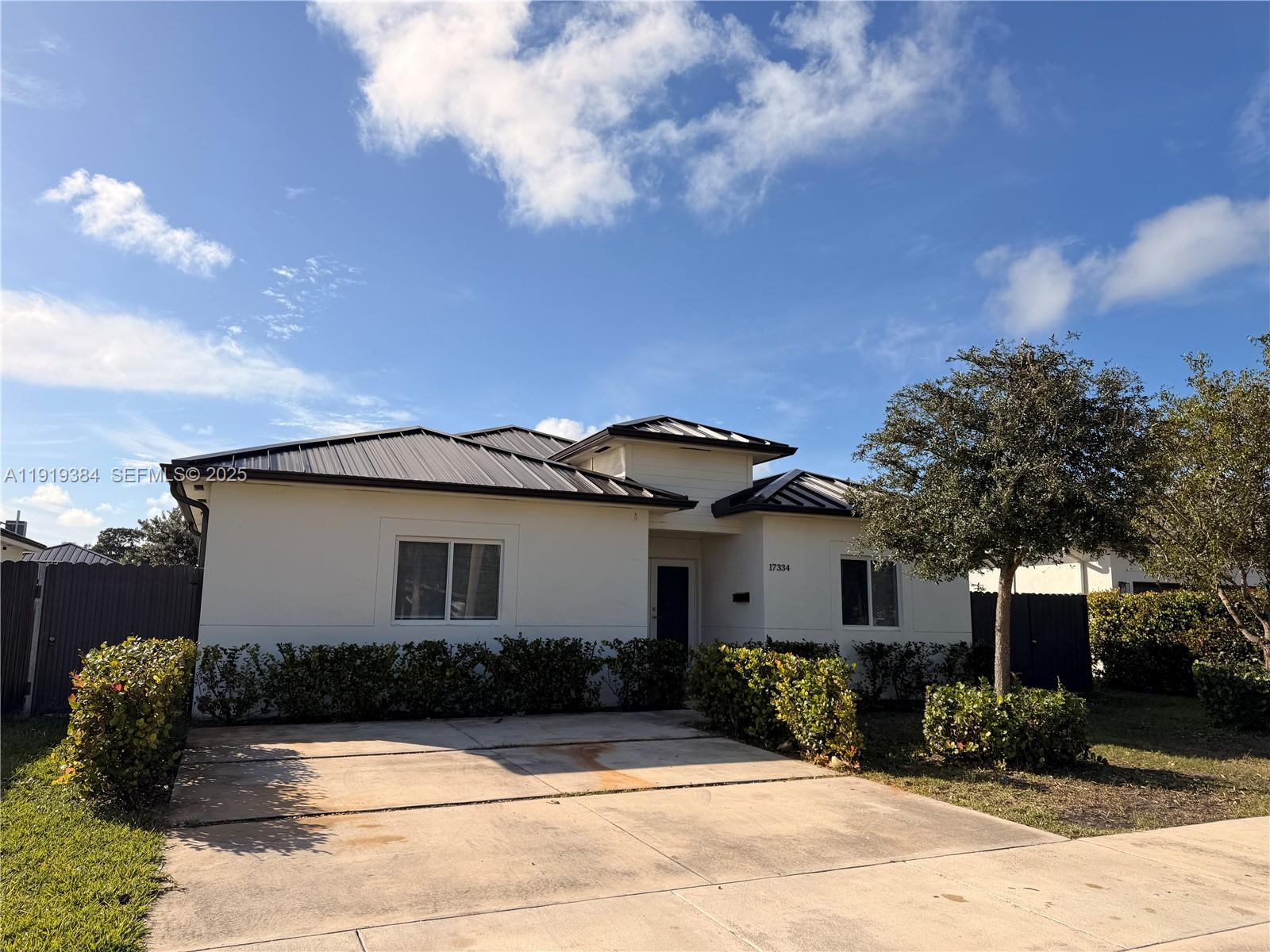 For sale in the heart of Homestead — spacious single-family home with no HOA, featuring a 4-bedroom, 2-bath main home plus a 1-bedroom, 1-bath in-law suite with a private side entrance, perfect for extended family or guests. This beautifully finished residence offers an open-concept floor plan with high ceilings, large modern tiles throughout, a wrap-around kitchen overlooking the private fenced backyard, elegant bathrooms with floating vanities and lighted mirrors, a full-size laundry room, and impact windows and doors for peace of mind