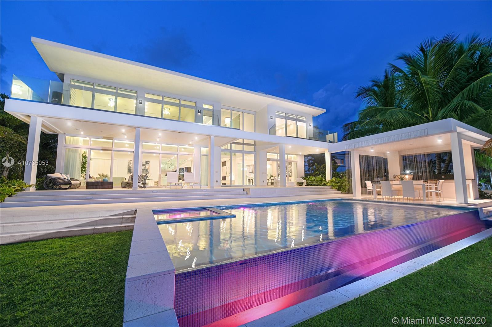 Impressive Miami Beach waterfront home with breathtaking open bay views of Biscayne Bay and Downtown Miami’s skyline. (larger than tax roll) This sprawling 7,763 SqFt modern residence features 6 bedrooms, 7 bathrooms, plus office space, a 3 car garage to show case your collection and an oversized 13,940 SqFt gated lot. This home feels like a trophy yet still carries all the comforts of a family home. Marble floors and custom Pedini kitchen with Miele appliances adorn this oasis. The Impressive summer kitchen and large pool, with a cascade feature, offer the perfect environment to unwind. other features include 83 linear feet of water frontage, 30,000 boat lift, jet ski ramps and rooftop sundeck.