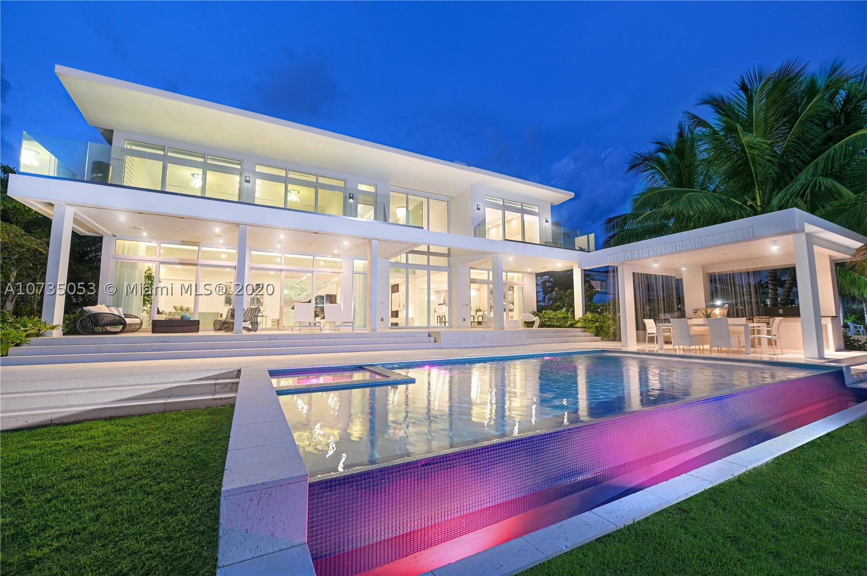 Impressive Miami Beach waterfront home with breathtaking open bay views of Biscayne Bay and Downtown Miami’s skyline. (larger than tax roll) This sprawling 7,763 SqFt modern residence features 6 bedrooms, 7 bathrooms, plus office space, a 3 car garage to show case your collection and an oversized 13,940 SqFt gated lot. This home feels like a trophy yet still carries all the comforts of a family home. Marble floors and custom Pedini kitchen with Miele appliances adorn this oasis. The Impressive summer kitchen and large pool, with a cascade feature, offer the perfect environment to unwind. other features include 83 linear feet of water frontage, 30,000 boat lift, jet ski ramps and rooftop sundeck.