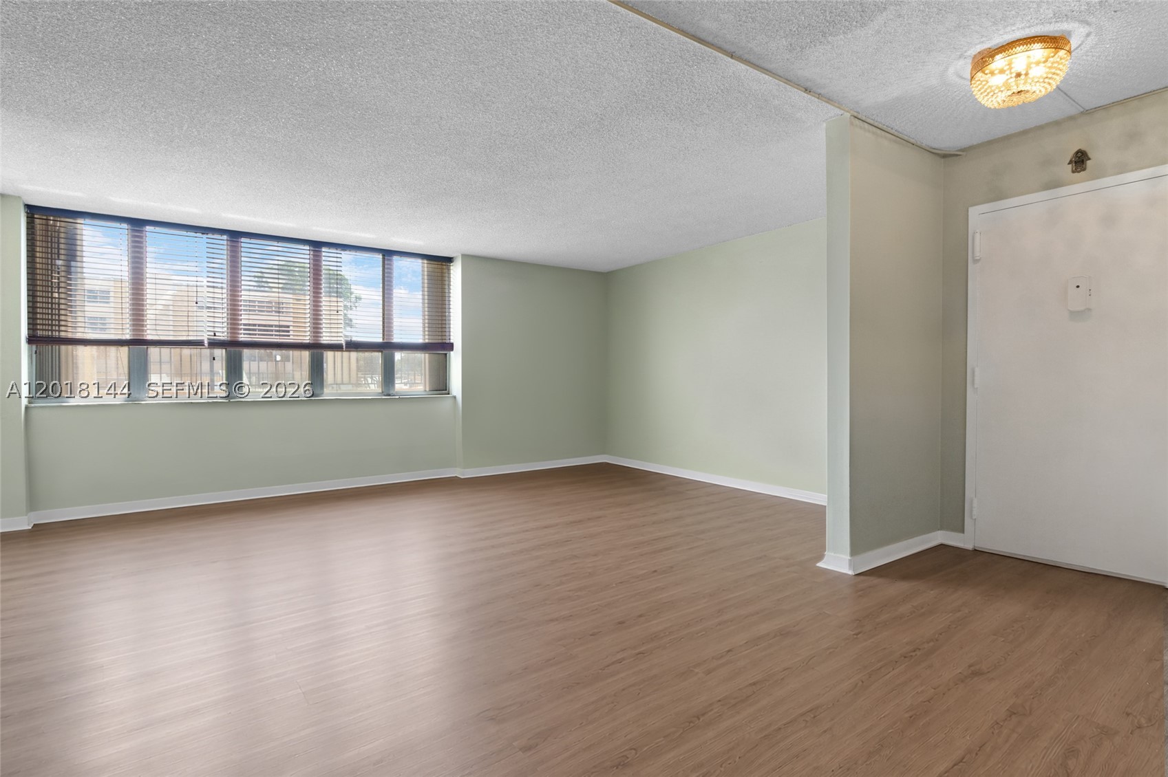 Feels like a single-family home with 1,700 sq. ft. and an intentional, well-designed layout. This spacious 3-bedroom, 2-bath ground-floor condo offers comfort and functionality throughout. Features include an updated kitchen and bathrooms, new A/C system, and new flooring. The enclosed balcony adds valuable extra living space, ideal for a den, office, or play area.  The unit includes two assigned parking spaces along with ample guest parking. Conveniently located directly across from the community pool, playground, and clubroom.  Situated in a desirable Kendall neighborhood with access to A-rated elementary, middle, and high schools. Property presents an excellent opportunity for a buyer to add personal touches.