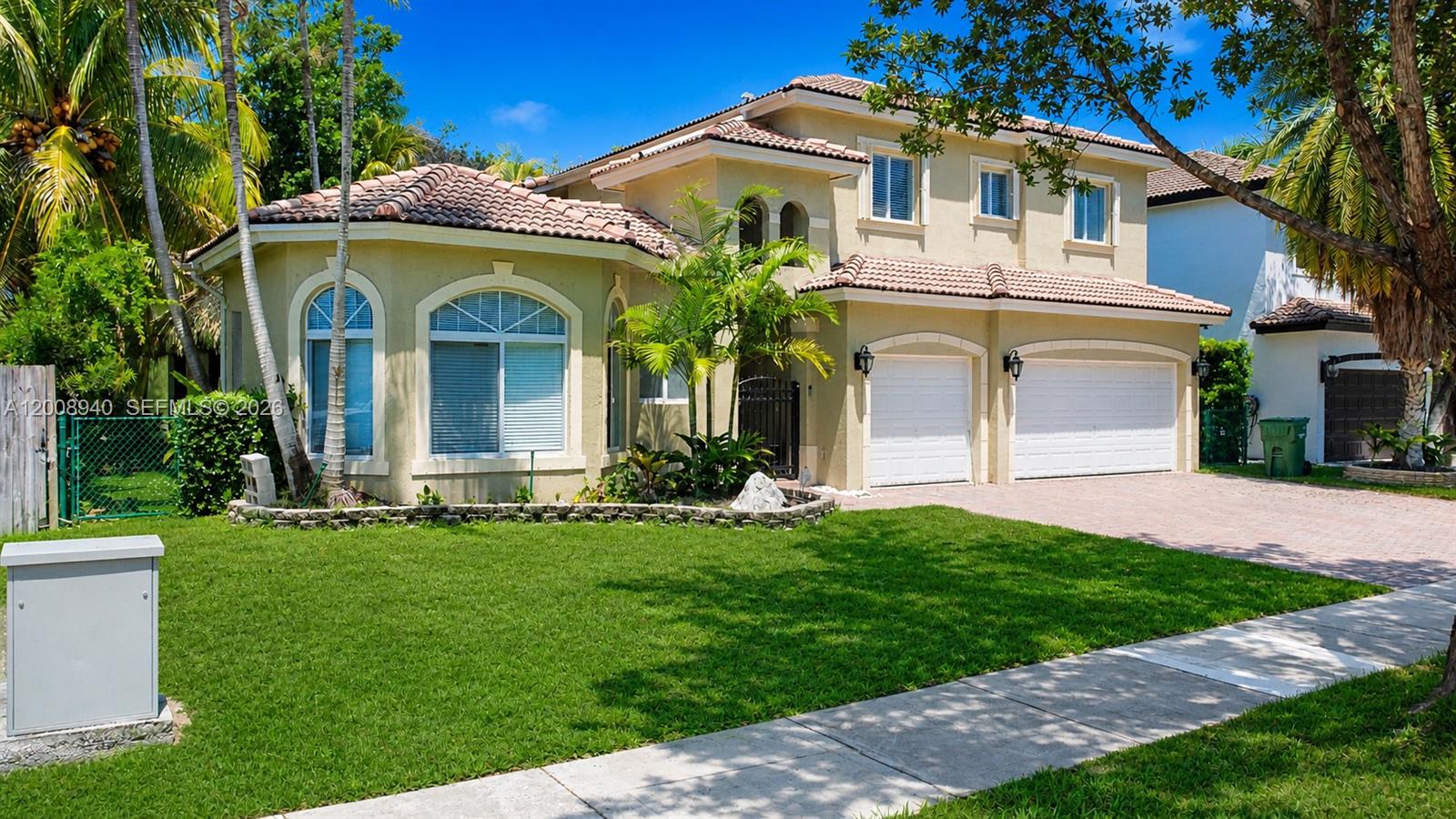 This rare five-bedroom, four-bathroom home in the highly sought-after Palm Isle Estates offers an exceptional combination of space, style, and flexibility that is truly hard to find. Designed for comfortable living and effortless entertaining, the home features nine-foot ceilings, ceramic and laminate flooring throughout, and a versatile layout that includes separate in-law quarters -- perfect for multi-generational living. The upgraded kitchen is a standout with granite countertops, 2024 appliances, and a wine fridge, while smart home features including Nest and Ring add modern convenience. Major updates include a newer A/C unit (2024), a water softener system, accordion shutters, and gutters throughout. Step outside into your own private retreat featuring a charming tiki hut, a beautifully updated backyard with turf installed in 2024, a screened terrace with fans, and a courtyard perfect for relaxing or hosting. Tropical fruit trees including banana and coconut complete this lush outdoor escape. Located in Palm Isle Estates, this is a rare opportunity to own a home that truly has it all -- space, upgrades, and the flexibility to grow with your lifestyle.