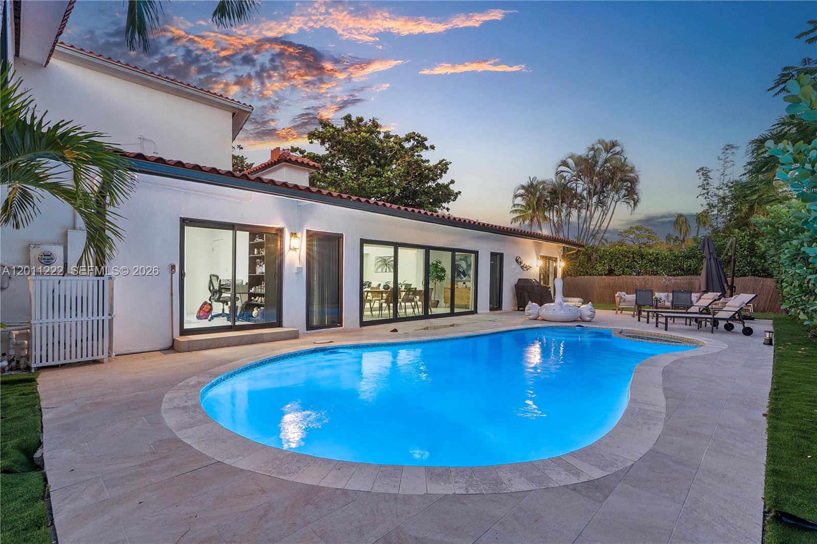 Experience modern luxury with a touch of timeless style in the heart of Miami Shores. This stunning, fully updated home spans nearly 4,000 square feet on an 11,500-square-foot corner lot, offering expansive living spaces, an open-concept layout, and soaring ceilings that flood the interiors with natural light. The main-floor primary suite includes a spa-like bathroom and generous walk-in closets, while the home’s five bedrooms feature large, comfortable layouts ideal for family and guests. A beautifully modernized Art Deco aesthetic flows throughout, highlighted by charming architectural details—including a Juliet balcony that adds character and charm. The contemporary kitchen comes equipped with modern appliances including a dishwasher, and the home also features in-home laundry and a two-car garage. Outdoors, enjoy a private below-ground pool and ample yard space perfect for entertaining or relaxing.