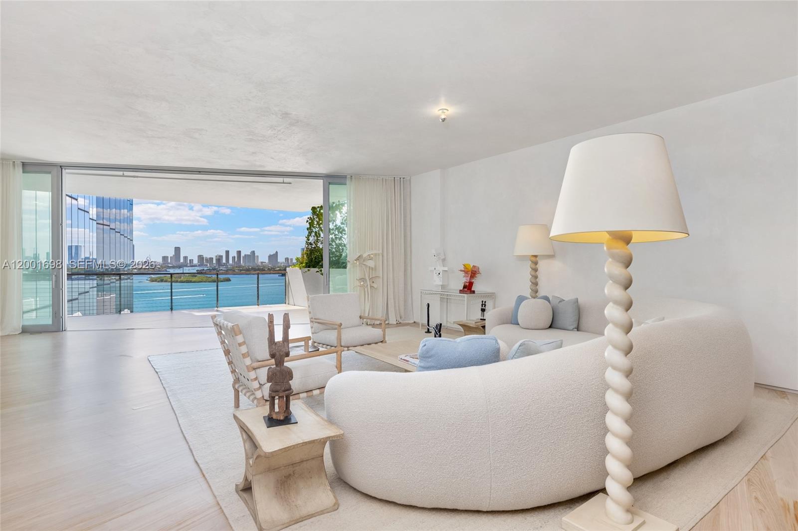 A striking bayfront residence defined by architectural significance, refined interiors, and breathtaking sunset views across the Miami skyline.

Located within Monad Terrace, the iconic waterfront development by Jean Nouvel, this expansive 5-bedroom, 5 full and 1 half-bath flow-through residence offers 4181 square feet of interior living, complemented by over 1,284 square feet of private terraces. Designed to maximize light and exposure, the home captures sweeping Biscayne Bay and city skyline views with both sunrise and sunset exposures.

A private elevator foyer opens to a grand great room with dramatic scale, Venetian plastered walls and ceilings, and custom built-in bookshelves. The sculptural kitchen is anchored by an oversized island and features Calacatta gold marble surfaces, premium Gaggenau appliances, and a custom-built breakfast table for elevated entertaining.

The primary suite offers a spa-inspired marble bath with soaking tub and steam shower, while all bathrooms feature exceptional stonework. A fifth bedroom has been converted into a dedicated laundry and staff room.

Expansive terraces provide multiple lounge areas oriented toward unobstructed bay and skyline views. Residents enjoy access to Monad Terrace’s waterfront pool, fitness center, spa, and full-service amenities.
