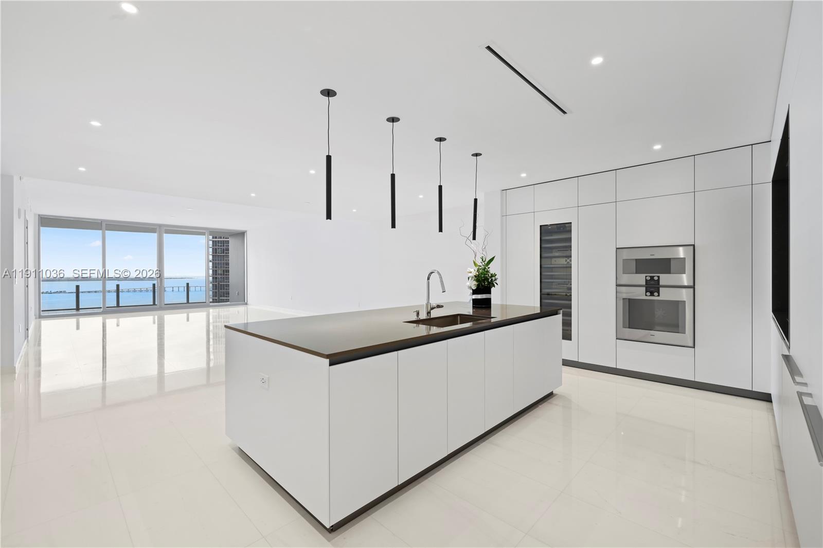 Experience luxury living in this brand-new unit at the prestigious Aston Martin Residences Miami. This exquisite 4 Bedroom + Staff 5.5-bathroom residence defines sophistication and elegance. The design embodies the iconic style of the automotive brand, enhanced by stunning views of Biscayne Bay and Miami Beach from floor-to-ceiling windows and a spacious balcony. Enjoy the Sky Amenities level featuring 42,500 s.f. of luxury amenities, including an infinity pool, spa, private movie theater, and state-of-the-art gym. Inside, the unit boasts exceptional craftsmanship, with a gourmet kitchen outfitted with Gaggenau appliances, marble floors, and expansive windows that fill the space with natural light. The exclusive address offers a refined lifestyle of luxury and convenience. Brand New was never occupied.