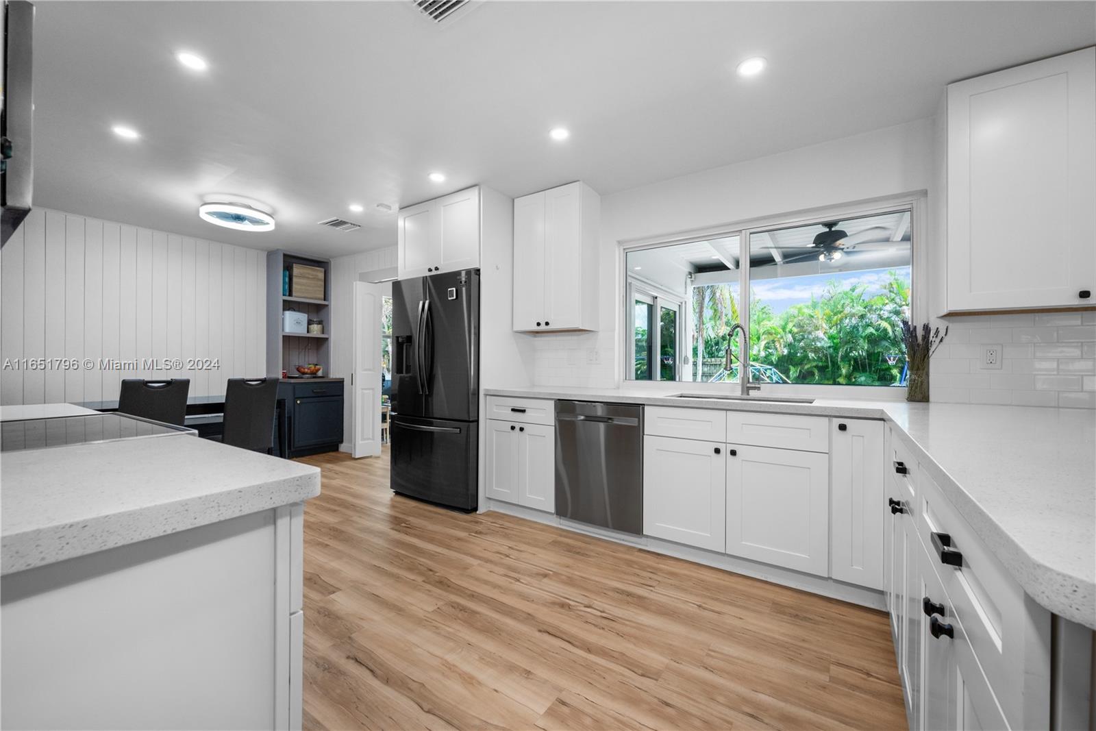 Beautifully renovated four-bedroom, two-bath home with office, set on a generous 11,483 sq. ft. corner lot with a spacious backyard. This home features a bright, airy living room with custom built-in cabinetry. The renovated kitchen is a standout, featuring custom cabinetry, quartz countertops, high-end appliances, and a breakfast nook. The property also has a small home office with its own private entrance, ideal for work or quiet time. Every detail has been thoughtfully updated, including impact windows/doors, modern bathrooms, luxury vinyl flooring, fresh paint, a new AC system, a tankless water heater, a large laundry/utility room, and an outdoor 220V outlet. Centrally located near highways, shops, dining, hospitals, and beaches, which adds additional convenience to day-to-day living.