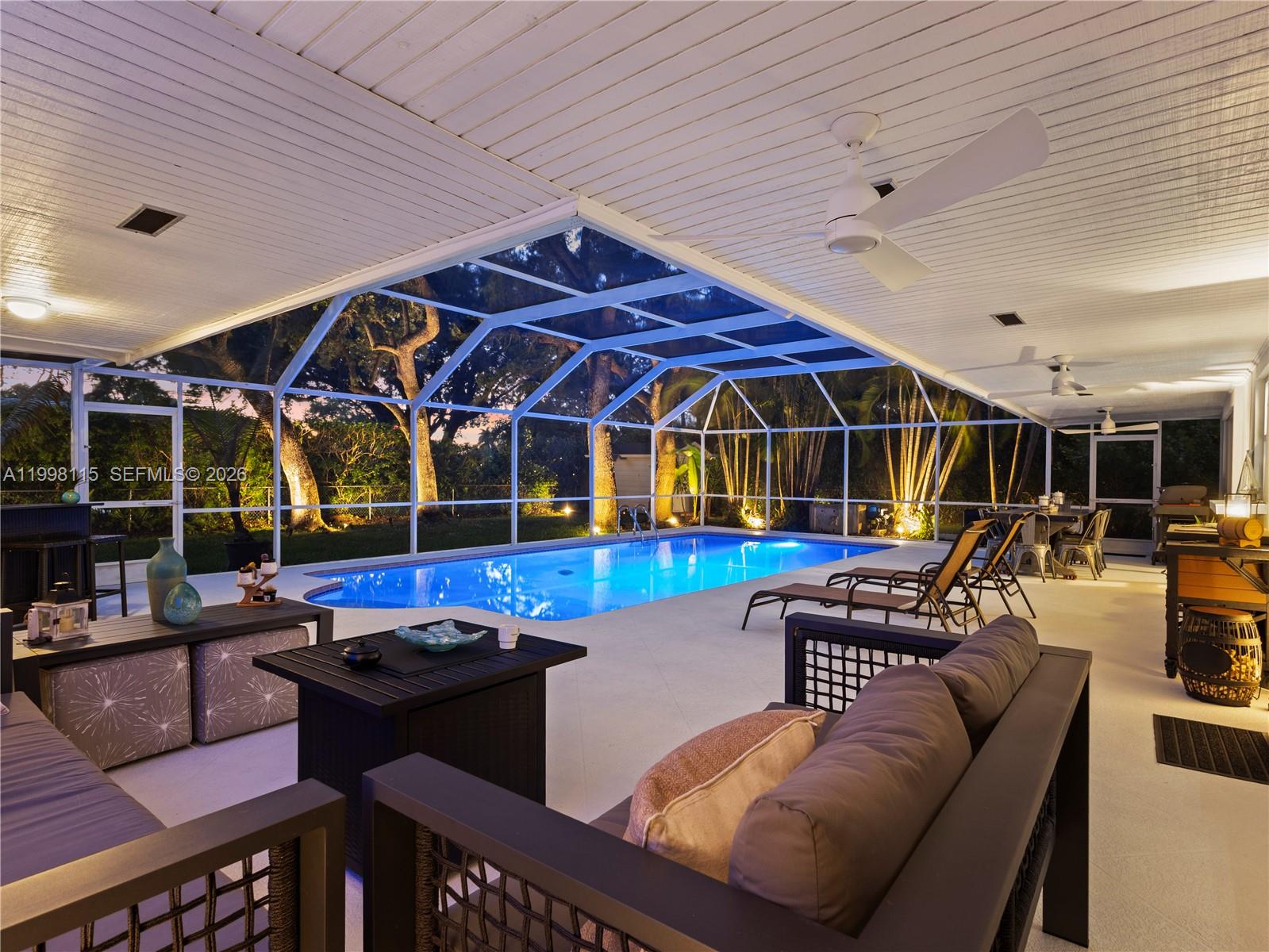 *New Roof 2026* Full Impact Windows & Doors, Turn Key/Move in Ready, Large Lot (17,000 SQ FT), No HOA. Fully Renovated Palmetto Bay Retreat | Designer Finishes | Resort-Style Pool & Outdoor Living. Experience refined South Florida living in this fully renovated residence located in the heart of Palmetto Bay. Thoughtfully redesigned with a focus on modern elegance, comfort, and functionality, this home offers a seamless blend of indoor sophistication and outdoor lifestyle. From the moment you arrive, the property stands out with its clean architectural lines, updated exterior, and striking evening presence. Inside, expansive living areas flow effortlessly, enhanced by new flooring throughout, abundant natural light, and a warm contemporary aesthetic. The kitchen has been tastefully remodeled with modern finishes, sleek cabinetry, and an open layout ideal for both everyday living and entertaining. Multiple living areas provide flexibility for hosting, relaxing, and family life. The primary suite offers a private retreat with a fully updated bathroom featuring spa-inspired design and high-end finishes.
The outdoor space is a true highlight. The covered terrace and screened pool enclosure create a private, resort-style setting, complemented by custom landscape lighting and mature greenery—perfect for both quiet evenings and entertaining guests.
