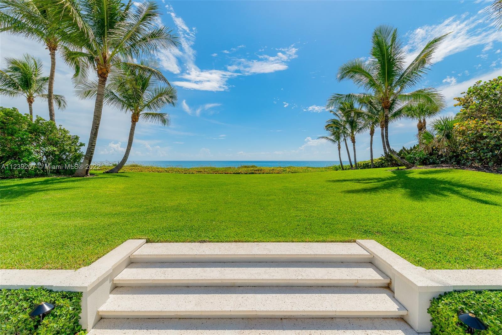 A move-in ready and fully furnished Oceanfront estate on Jupiter Island is available for purchase. 
This home, hidden beyond a Banyan tree canopy entrance, features 1.83-acres and a sprawling 200’ of beach frontage that allows for expansive outdoor space and privacy. Feel secure knowing the property has been completely remodeled from top to bottom with quality materials, finishes, and fixtures, including Impact Glass windows and doors, a Generator, new AC systems, and Roofs less than ten years old. Enjoy this Jupiter Island estate with ocean views, a large oceanside pool, a motorized louvered pergola, and a well-equipped outdoor kitchen.