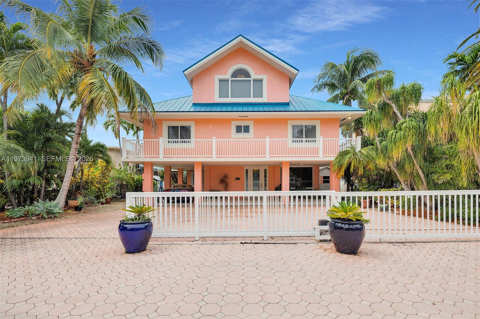 1218 Mockingbird Rd, Key Largo, FL 33037 tropical luxury coastal living in the heart of Key Largo turn key on Oceanside Canal 700 feet to the open ocean four bedrooms, three baths 3065 feet living square feet lot is 7645 ft.² parking for four cars +2 in carport 70 feet of seawall with a boat cut in and a lift 16,000 pounds can accommodate a 30 foot boat also a lift for two jet skis home was remodeled in the year 2000 2011 2019 the master suite is on the entire third floor. It was made for a queen, absolutely beautiful, walk-in shower, jetted tub, private commode, area windows overlooking the water. Second floor, gourmet kitchen with new subzero refrigerator double door six burner gas stove. granite countertops throughout. large living room and dining area overlooking the water walk out onto the wraparound porch, which is beautiful. two bedrooms and a bath on the second floor. first floor walk in large family room, walk-in shower and bathroom storage area. overlooking the water. walk out onto the large covered patio with a hot tub and a bar when home was remodeled it was all done with hurricane sliding patio doors and windows throughout and a commercial metal roof. Home has never had any hurricane damage sits high and dry. Don’t miss out on this great opportunity to own the tropical paradise.
