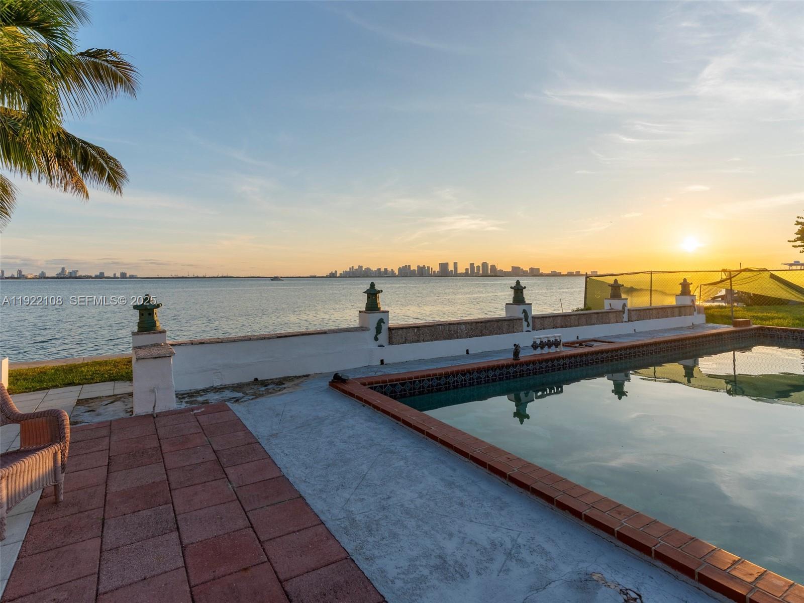 Stunning waterfront home on Treasure Island offering SPECTACULAR PANORAMIC VIEWS of Biscayne Bay, the Miami skyline, and Miami Beach!! With 60 ft of direct bay frontage, a double seawall, no fixed bridges, and wide-open ocean access, this property is ideal for boating enthusiasts. The 4-bed, 4-bath residence sits on a 9,000 SF lot and features vintage Cuban tiles and hardwood floors. Enjoy as is, or redevelop into your dream estate with some of the best views in Miami. Just blocks from Normandy Shores Golf Course. Unforgettable sunsets and 180 degree unobstructed vistas—an exceptional opportunity.