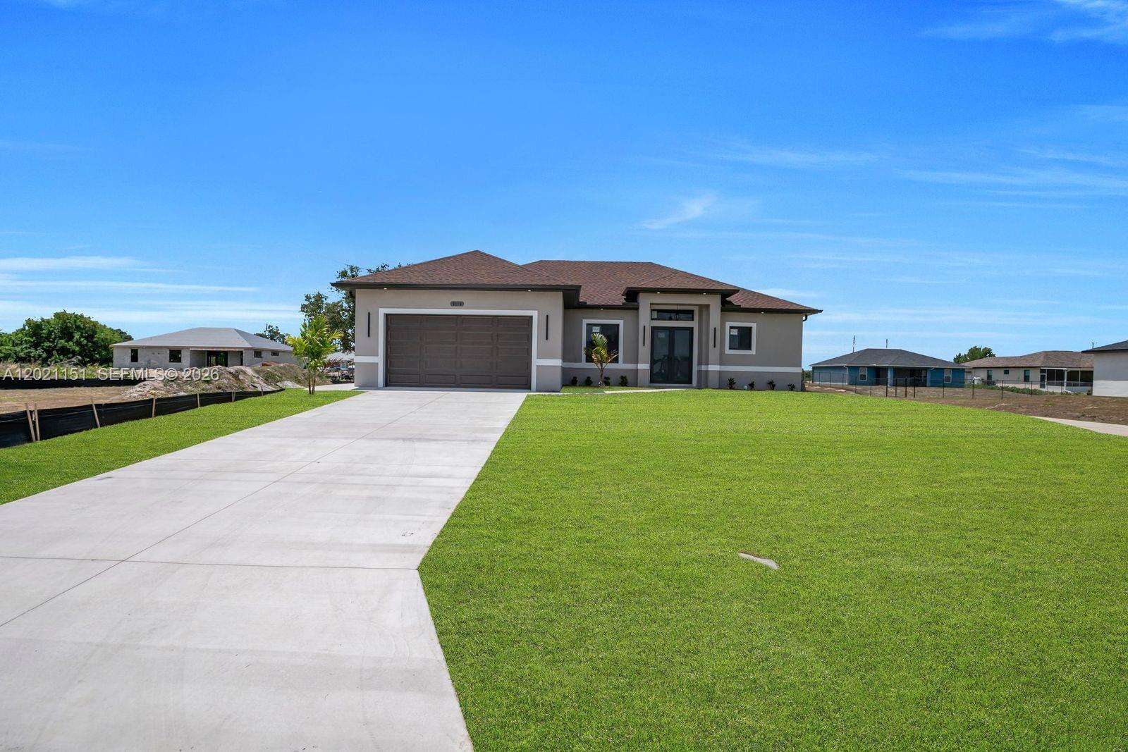 Welcome to this stunning modern NEW CONSTRUCTION home at 3115 2nd St SW, Lehigh Acres, FL 33976. Featuring 1,780 sq ft of living area on a desirable corner lot, this residence was designed with today’s buyer in mind—clean lines, open spaces, and stylish finishes throughout. Step inside to a bright, open-concept layout with a spacious living and dining area that flows seamlessly into the kitchen—perfect for entertaining and everyday living. The interior showcases a sleek, contemporary look with modern lighting, updated fixtures, and a fresh, neutral palette that complements any décor. The kitchen offers a modern feel with ample cabinetry and workspace, ideal for meal prep and hosting. This home includes 3 bedrooms + a den (great for a home office, playroom, or guest space), 2 bathrooms, and a double garage. The primary suite is thoughtfully laid out with a comfortable bedroom space and a private bath, while the additional bedrooms offer flexibility for family or guests. Additional highlights include impact windows and a washer & dryer included for added convenience. Conveniently located just 2 minutes from Lee Blvd and Sunshine Blvd, you’ll have quick access to shopping, dining, schools, and major roadways. A fantastic opportunity for homeowners or investors—schedule your private showing today!