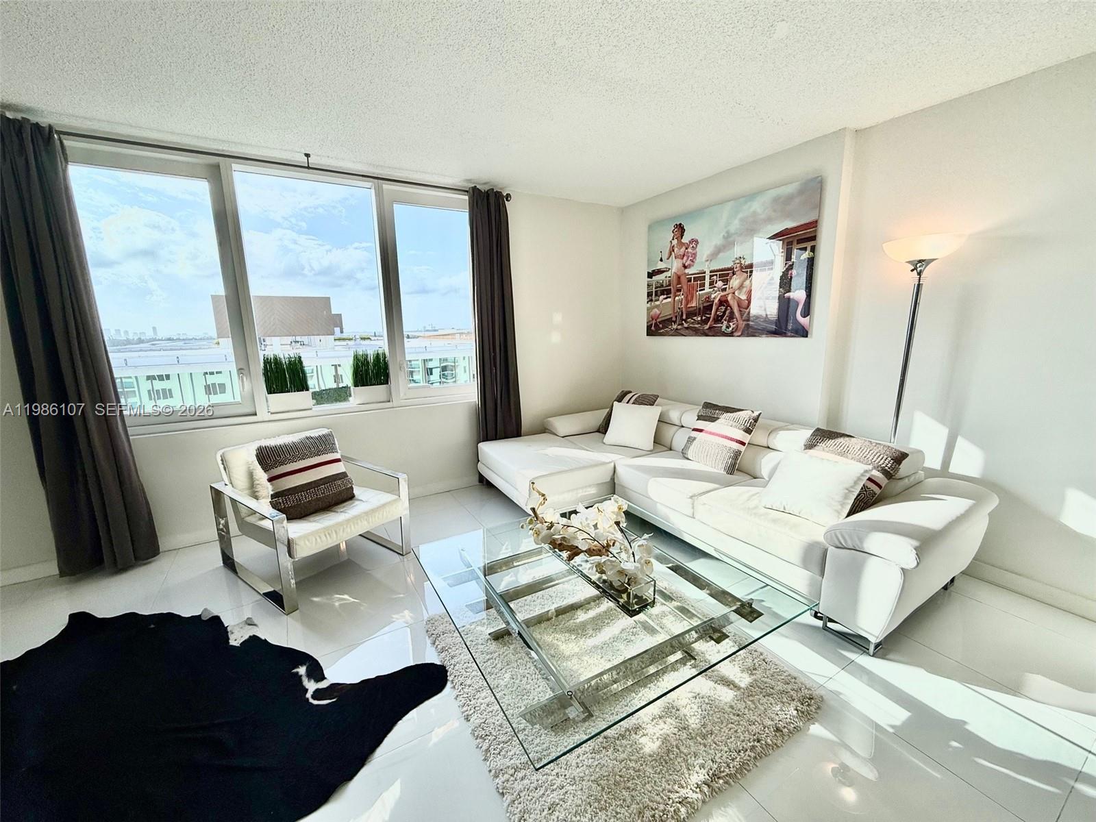Beautifully updated 9th-floor residence offering unobstructed city skyline views and stunning year-round sunsets. This spacious 760 SF unit is thoughtfully converted into a comfortable 1-bedroom with a bright, open layout, sleek white flooring, and a modern kitchen with black counter-tops and ample seating. The elevated floor opens expansive views to the sky with no buildings blocking the horizon, filling the space with natural light. Located in the heart of South Beach, directly on the ocean and steps from the W Hotel and Setai, this residence sits within the iconic 1 Hotel South Beach complex. The building has been fully renovated, including lobby, hallways, and common areas, and residents enjoy access to world-class 5-star amenities: multiple oceanfront pools, beach service, restaurants, cafés, gym and spa. Flexible rental policy allows up to 12 rentals per year (30-day minimum). The unit holds all required city and county licenses for legal short-term rentals (30+ days) and has a proven 10-year Airbnb rental history. Turnkey opportunity ideal for both end-users and investors seeking luxury, location, and income potential.