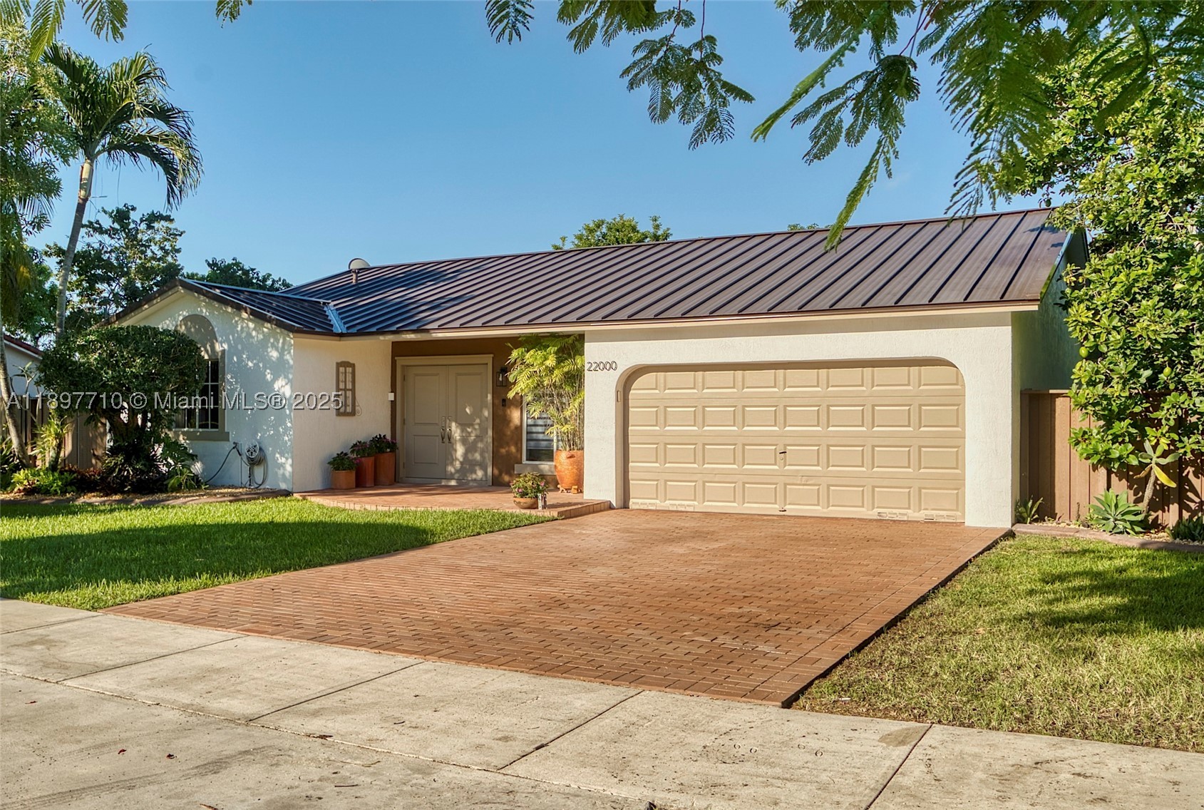 Impeccable and beautifully maintained! This completely remodeled and modernized residence offers 3 bedrooms/2 bathrooms with a two car garage on a 12,500 sf lot that features an impressive fruit tree inventory. New metal roof 2022, new A/C 2021, freshly painted in and out, same consistent ceramic tile throughout (even in the garage), custom closets, upgraded doors/moldings & hardware, new W&D, composite fence, custom built storage shed, termite tented Sept 2025, and so much more! Truly a turn-key perfect home, no detail left unattended. If you like outdoor living/entertainment, this is your dream home with a beautiful composite wood deck overlooking a collection of over 20 exotic fruit trees, flowering plants and orchids. Schedule a private tour today before it's too late!!