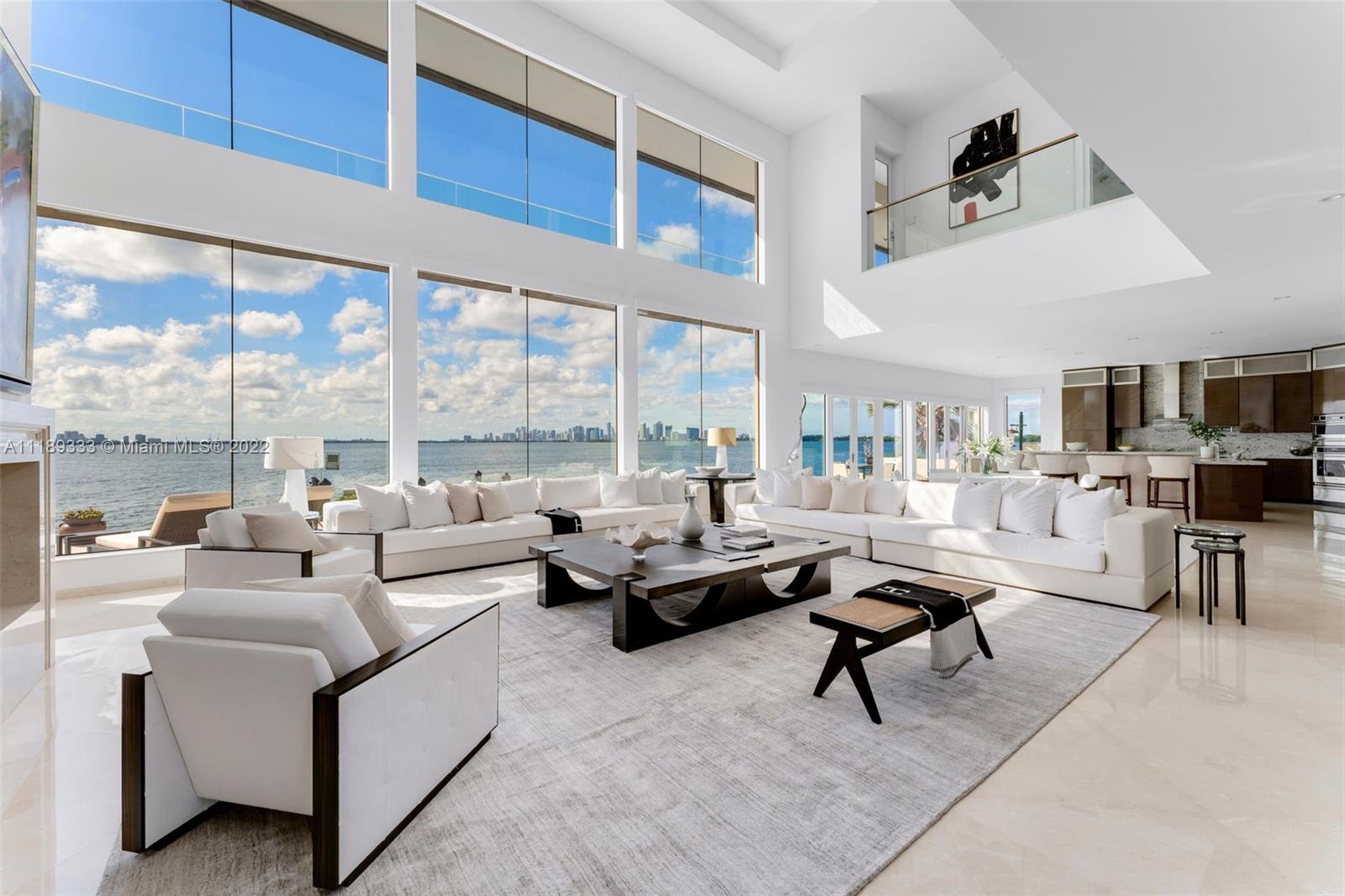 Experience breathtaking open bay views from this waterfront estate. Designed to maximize water views from every angle, direct Miami Skyline views take your breath away as you walk in and are enveloped by 23’ ceilings. This 4 bedroom, 4 full & 1 half bathroom, 5,782 SF home sits on a 8,858 SF lot with 103’ of water frontage. With a private dock & ocean access for your yacht. Features include an elevator, Savant smart home system throughout, surround sound, marble floors, gourmet kitchen with a cooking island & Thermador appliances, wet bar, gym with full bathroom, movie theatre, fireplace, 4 balconies, principal bedroom with seating area and spa shower. The outdoors are complete with a pool & spa, swim jet, outdoor fire pits, automatic retractable shades and views as far as the eye can see.