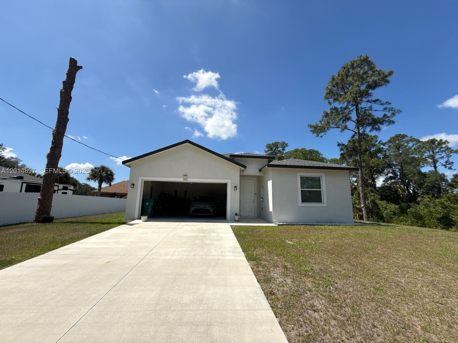 BUYER INCENTIVES AVAILABLE! Welcome to this house built single-family home in the heart of Labelle, offering modern comfort with a touch of Southern charm. This beautiful residence features 3 bedrooms, 2 bathrooms, and approximately 2060sq ft of living space with an open-concept layout. Enjoy a stunning kitchen with quartz countertops, stainless steel appliances, and a peninsula island. The primary suite includes a walk-in closet and elegant en-suite bath with dual sinks and walk-in shower. Energy-efficient windows, 2 car garage with a bay for an additional 4 cars., and private backyard. Conveniently located near schools, dining, and recreation. Seller offering $10,000 in incentives!