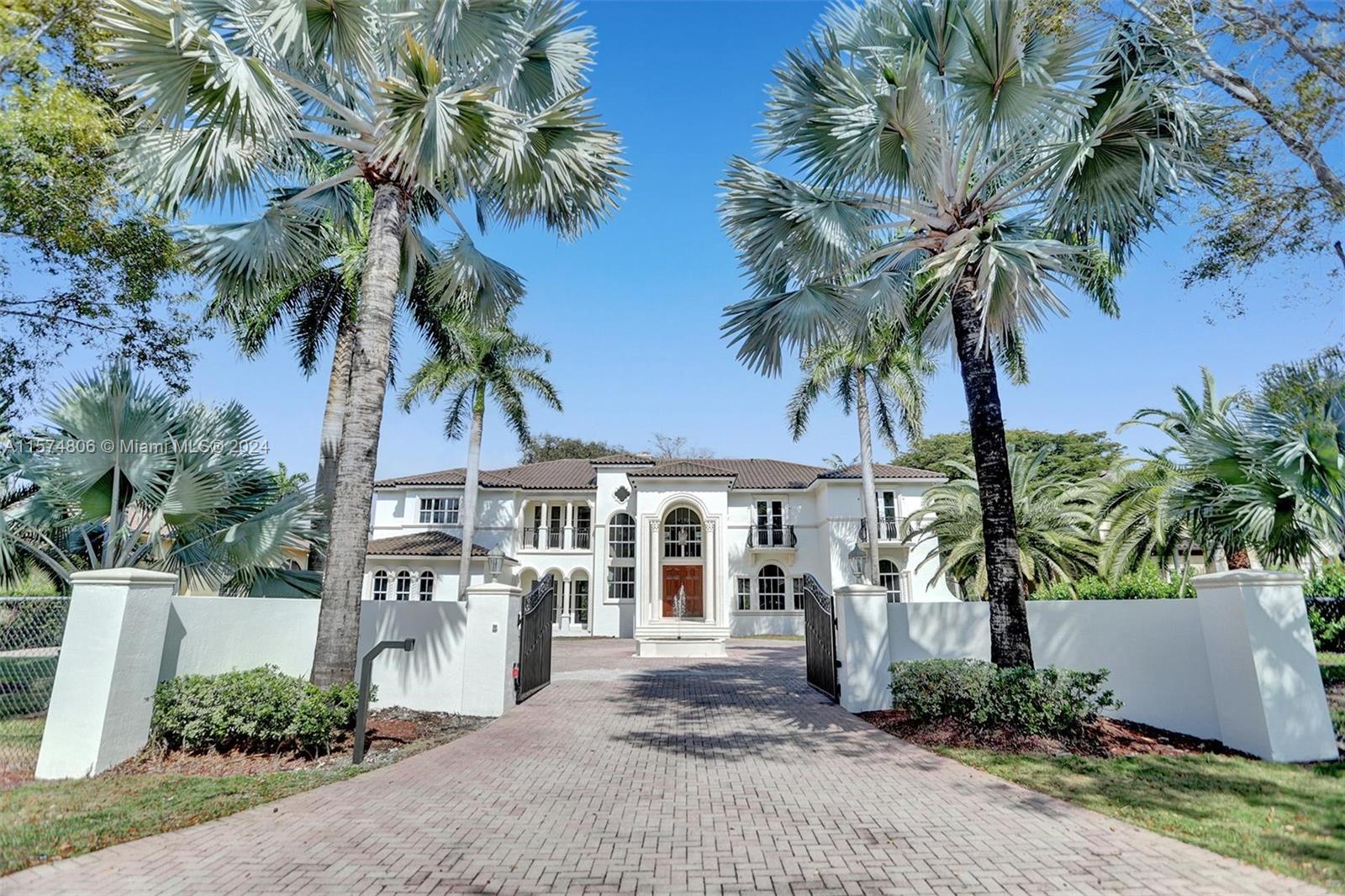 Two Story Mediterranean Estate in North Pinecrest situated on a deep tropical acre. Walled entry offering security and privacy. Distinguished entry with soaring ceiling and beautiful grand staircase. Elegant formal dining room, and formal living room with stone fireplace, beautiful marble and wood floor throughout, spacious eat in kitchen designed for a large family and entertainment. Up and down bonus family rooms plus office. Enjoy the tropical landscaping in the stunning backyard with pool and separate summer kitchen. Desired Pinecrest school location, walk to park, Pinecrest Gardens, Wayside.   This home is a must see!
