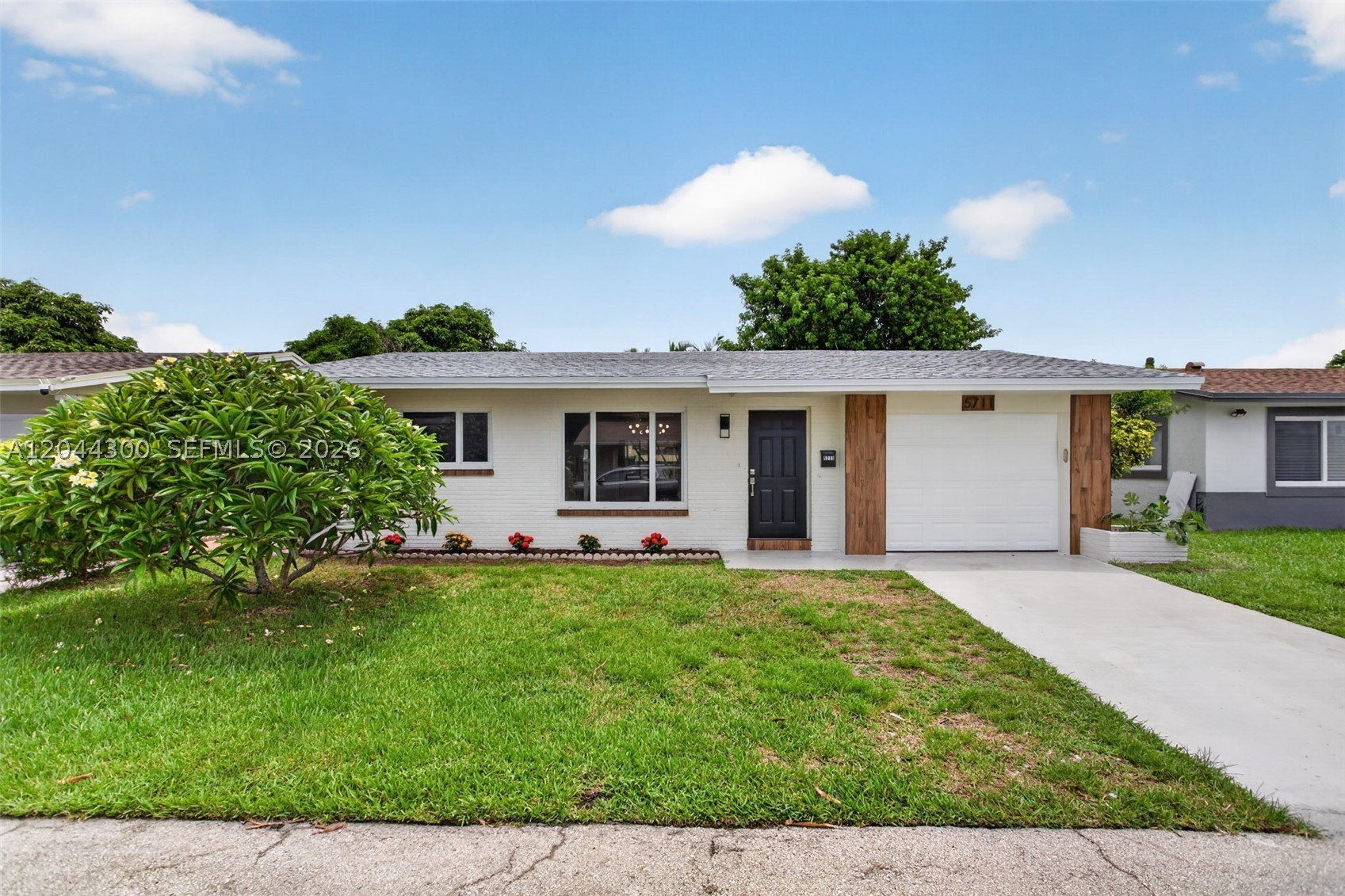 MUST SEE!!!  Tastefully upgraded home in an all ages community.  New roof, Impact windows, tankless water heater.  New flooring throughout, kitchen has real wood cabinets and a quartz counter tops.  New stainless steel appliances.  Low HOA fee.  Laundry room has a new washer and dryer and a laundry sink