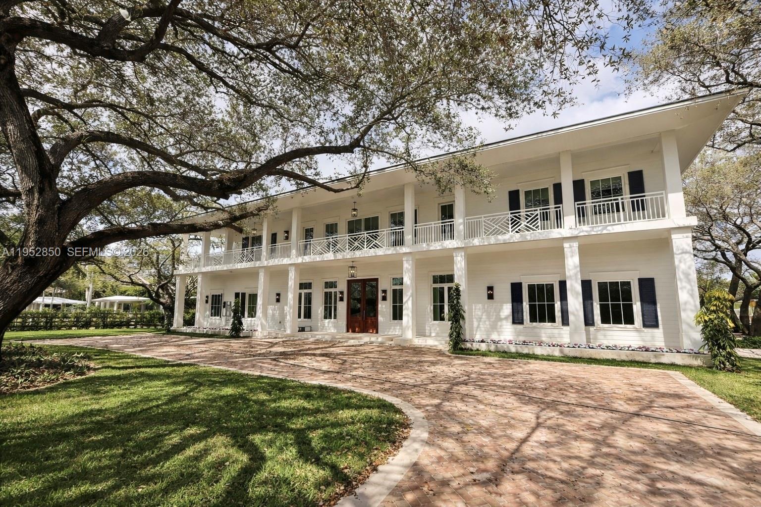 This stunning plantation-style estate blends timeless elegance with modern comfort on a prime corner lot. A grand foyer entry sets the tone, complemented by crown moldings, a gas fireplace, and refined architectural details throughout. The home offers six bedrooms, each with en suite baths, and a library and media room for work or leisure. The chef’s kitchen features designer appliances, custom cabinetry, a butler’s pantry, and wine storage, perfect for effortless entertaining. Dual laundry rooms on both levels add convenience, while French doors open to a covered terrace, open balcony, and summer kitchen overlooking a large saltwater pool with heated Jacuzzi. An elevator and pre-wiring for full home integration complete this exceptional residence.