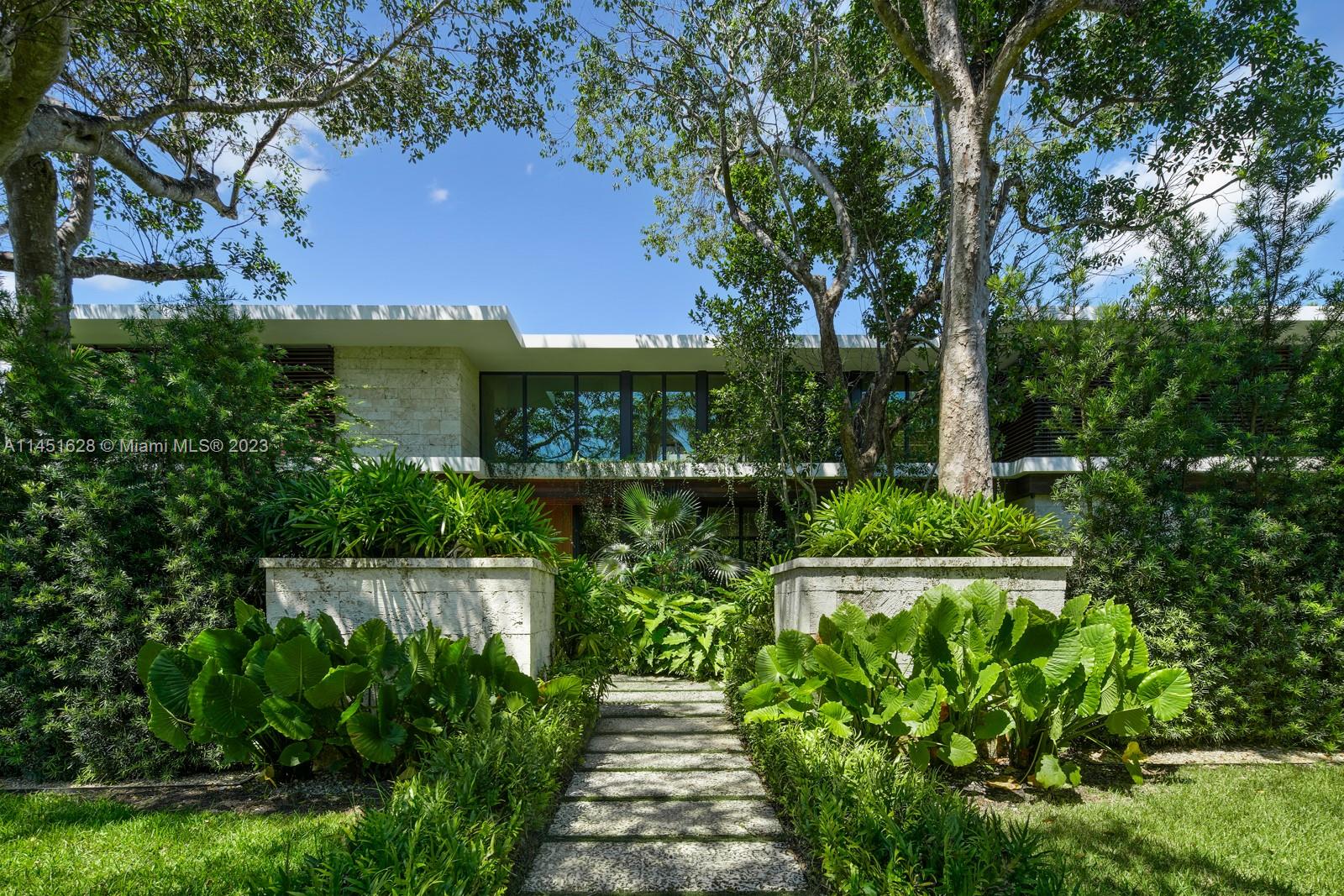 Nestled in the exclusive Hammock Lakes gated community, this modern architectural gem, designed by STRANG, redefines luxury living. Natural stone details both inside and out exuding minimalist sophistication. Among the 7 bedrooms, one is transformed to a home theater, another is currently a home office or use instead for live-in staff. Every inch of meticulous design, seamlessly blends aesthetics with functionality. Stunning kitchen features walk-in pantry, integrated cabinets, and picture windows to unify outdoor elements. European white oak floors, Crestron Smart home system. Step outside to a landscaped oasis, pebble-finish heated pool, fully-equipped summer kitchen, half court basketball & putting green to relish in the privacy and tranquility. 2-car garage. 2-car carport w/EV station.