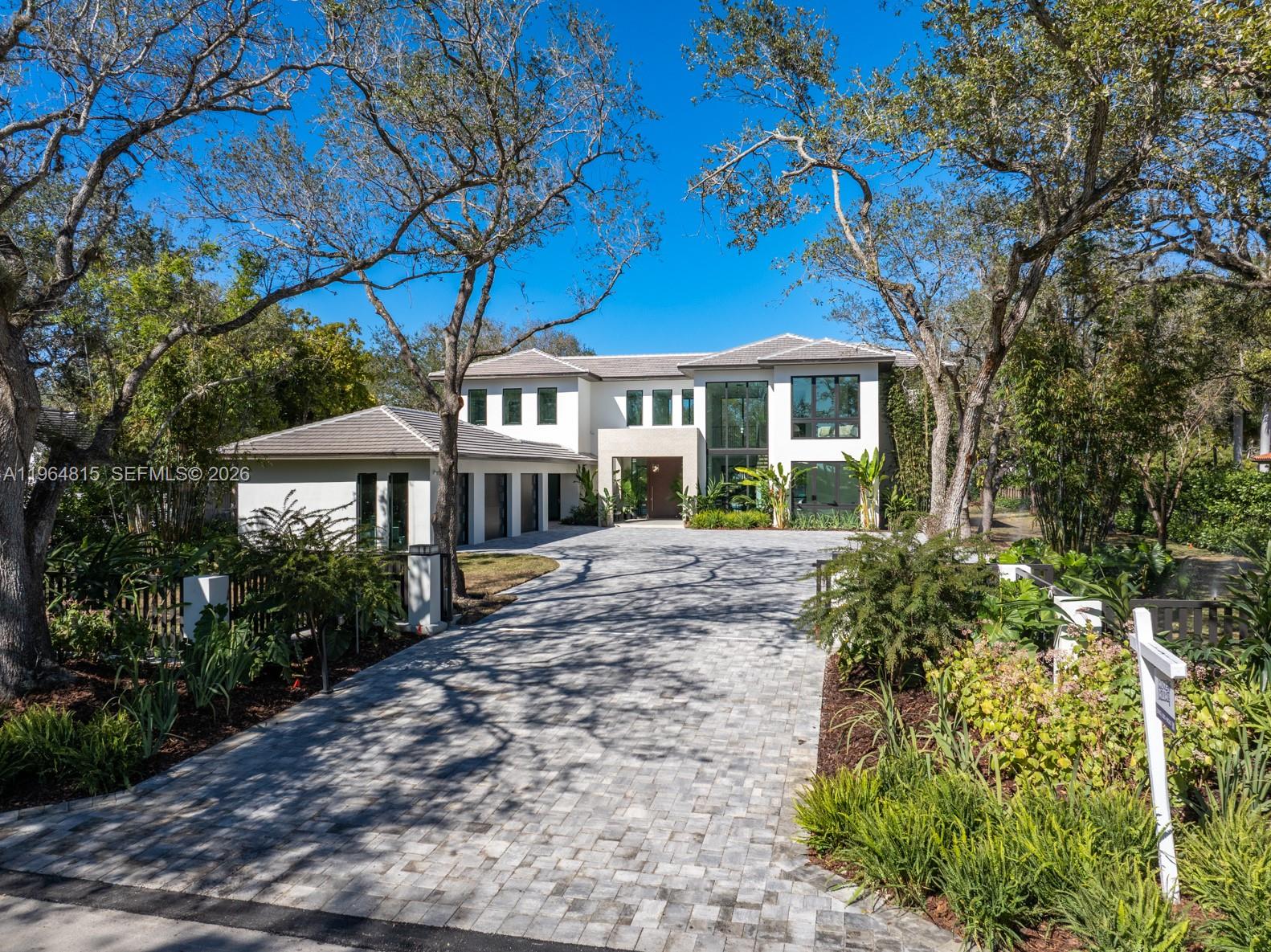 Experience luxury living at The Sanctuary at Galloway Glen, a private modern estate completed in February 2026. Set on an impressive 36,155 SF lot that stretches an entire block with access from both 99th and 100th street. This newly built estate offers exceptional privacy in one of Miami’s most peaceful and hidden neighborhoods. Total square footage is 6,565 SF, showcasing a thoughtfully designed layout with 5 spacious bedrooms—each with a walk-in closet—and 7 elegantly finished bathrooms. Floor-to-ceiling impact windows fill the interiors with natural light and create a seamless connection to the outdoors. A gourmet chef’s kitchen anchors the main living space, appointed with top-tier gas appliances and a spacious walk-in pantry. Extra large porcelain flooring and refined neutral finishes enhance the home’s modern aesthetic. Additional features include a 3-car garage, whole home gas generator, premium flat-tile roof, integrated indoor and outdoor speakers, alarm and security camera for peace of mind. Outside, a resort-style pool with built in hot tub, in pool lounge and expansive outdoor areas offer a perfect setting for relaxation and entertaining. This rare offering combines architectural elegance, modern amenities, and a premier location near top schools, marinas, parks and luxury shopping—an exceptional opportunity to own a true statement home in Galloway Glen.