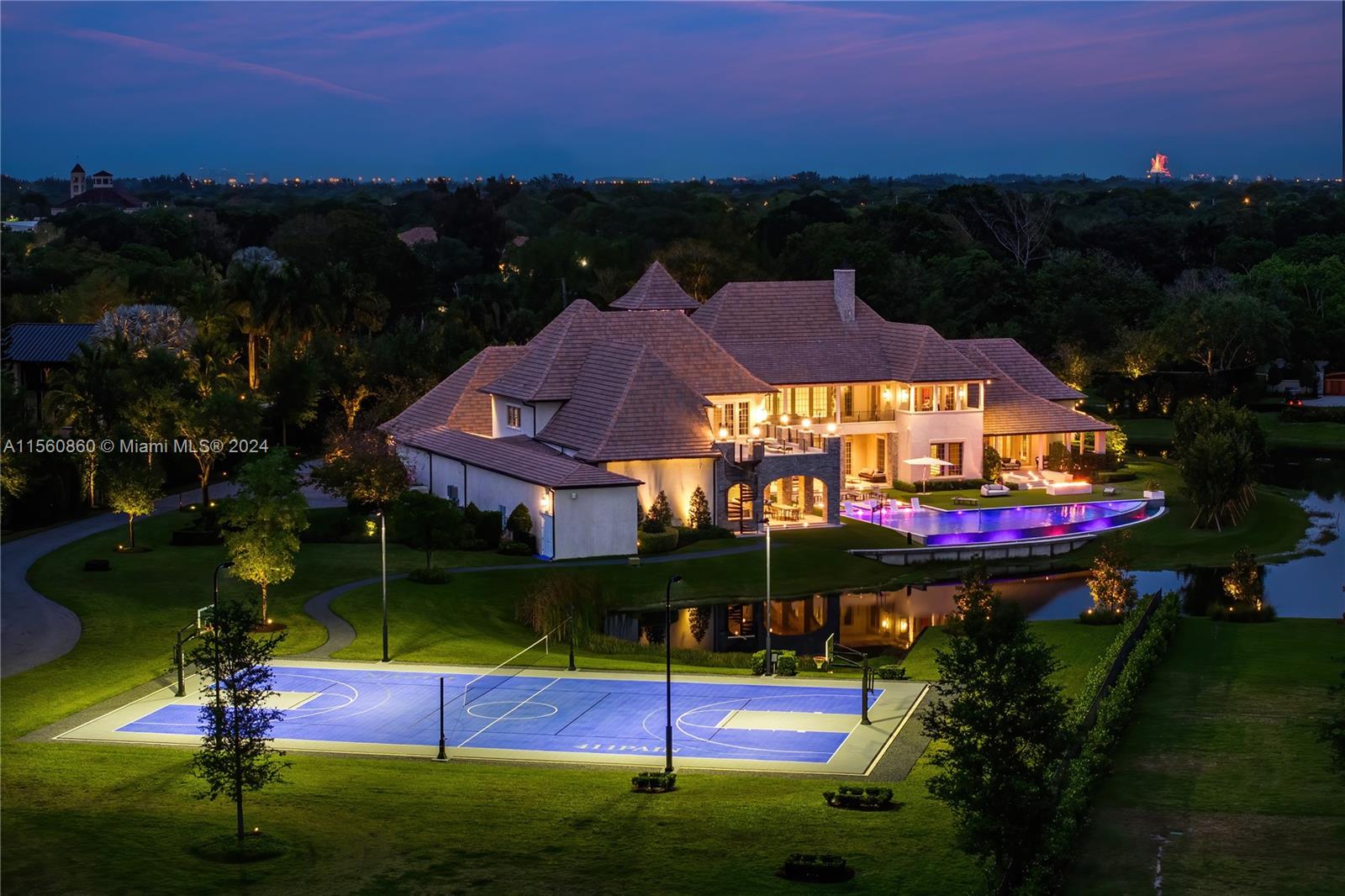 Experience the epitome of luxury with this custom French Country style mansion in Southwest Ranches. This home boasts over 15,000+ sq ft and features a movie theater, soaring ceilings, sprawling living areas, and resplendent bedroom suites. Outdoor amenities include an infinity pool, summer kitchen, and a full basketball court. Modern conveniences include Crestron Home Automation, a Generac generator, wolf appliances, and an automated privacy gate. Entertain throughout several entertainment areas that can host a multitude of guests. Embrace true serenity as the home is situated on a lot expanding nearly 5 acres that faces a 4 acre lake with custom fountains. Capture the opportunity to make this immaculate estate your next oasis.