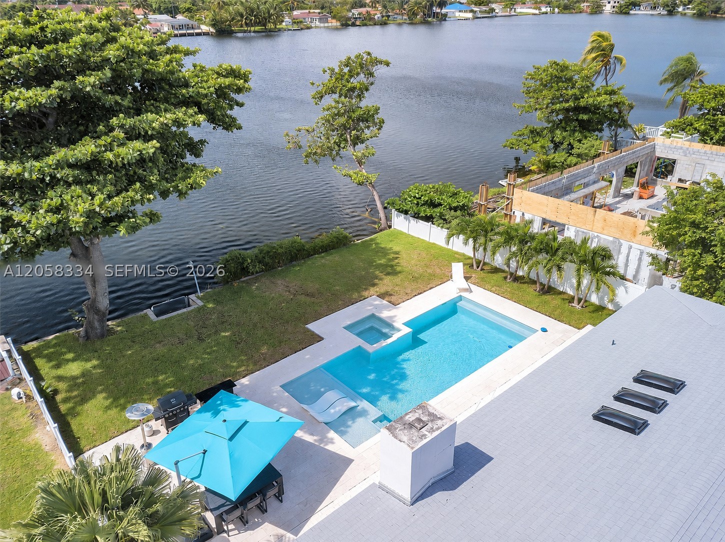 Experience waterfront living in this fully renovated 3-bedroom, 2-bath modern pool home in desirable Highland Lakes. Enjoy tranquil profound lake views (not canal) from the open living areas, primary suite and expansive backyard. Outdoor amenities include a resort-style pool, six-jet spa, tiki entertaining area, six-burner grill, outdoor refrigerator and seating for eight—perfect for relaxing or entertaining. The open-concept kitchen features a large island, quartz countertops, tile backsplash, skylights, stainless steel appliances and dual sinks with gooseneck faucets. Additional highlights include new impact windows throughout and a Samsung washer and dryer. Conveniently located near I-95, Aventura Mall, restaurants, beaches, parks and places of worship. The exceptional lake and pool views must be seen to be fully appreciated!