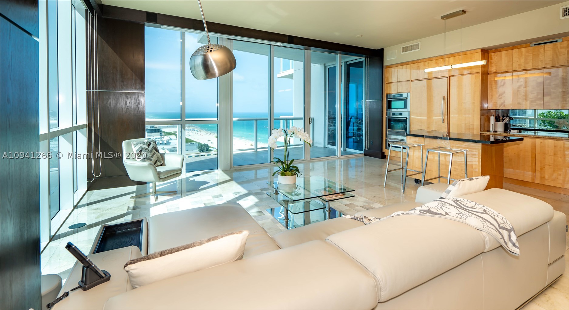 Extremely rare & unique (only 4) with 1000+ SFT spread over 3 covered terraces with sweeping views of the ocean, coastline, SoBe, Bay & Brickell. YES, you get the best of all worlds, from breakfast sunrise to romantic sunsets! Spacious DOUBLE corner unit, tons of 10 ft floor to ceiling impact windows, desirable split ensuite master bedrooms each with a private balcony. 92 inch projection TV with surround sound in living & master. Chef's kitchen w Subzero, Miele Appls. Marble & bamboo wood flrs, 2 wine coolers. Private fingerprint elevator direct to your unit. Over 12 lush acres of 5-star amenities incl 24-hour security, 3 tennis courts, private beach pavilion, 2 lagoon style pools, 23K SFT fitness, spa & lap pool. Turn-key furniture included, simply unpack & enjoy!  Space for home office.