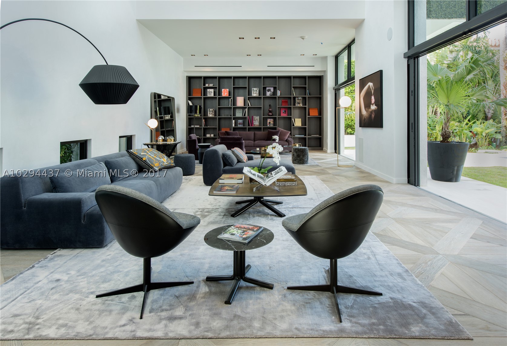 Ready for immediate enjoyment. Contemporary oasis w/ 11,500 sf of curated living & open bay sunsets. The sleek interior exudes unprecedented level of craftsmanship. Details include suede walls, ultra-luxury Italian furniture & Hermes decor for a turn-key living experience in Haute style. 100-foot mosaic pool w/ infiniti jacuzzi, BBQ pavilion, gym, massage lounge and private spa. 100 ft of expansive waterfront with dock & boat lift. Elevator to a massive rooftop garden w/ breathtaking Downtown Miami views.