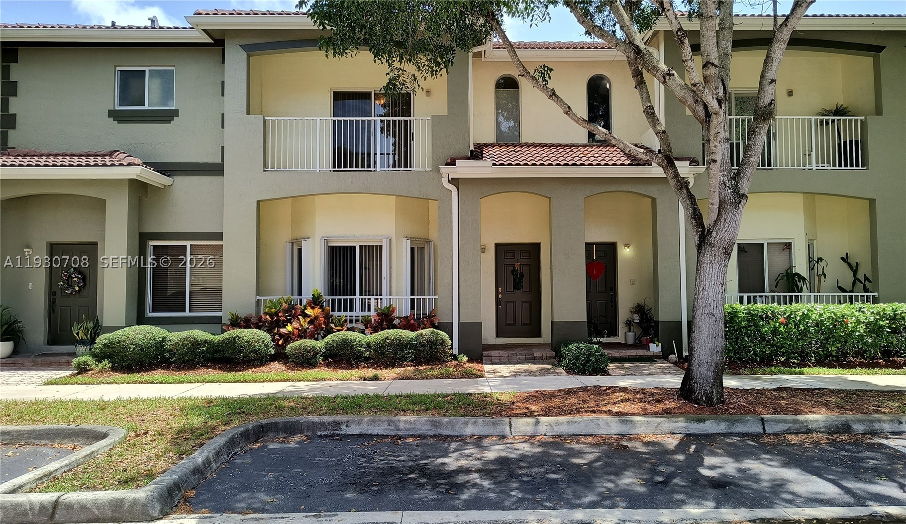 Two Story Townhouse with garage and balcony, parking in rear and front of building. Association fee includes insurance for building exterior, internet and media, alarm service, gated community, use of pool and playground.