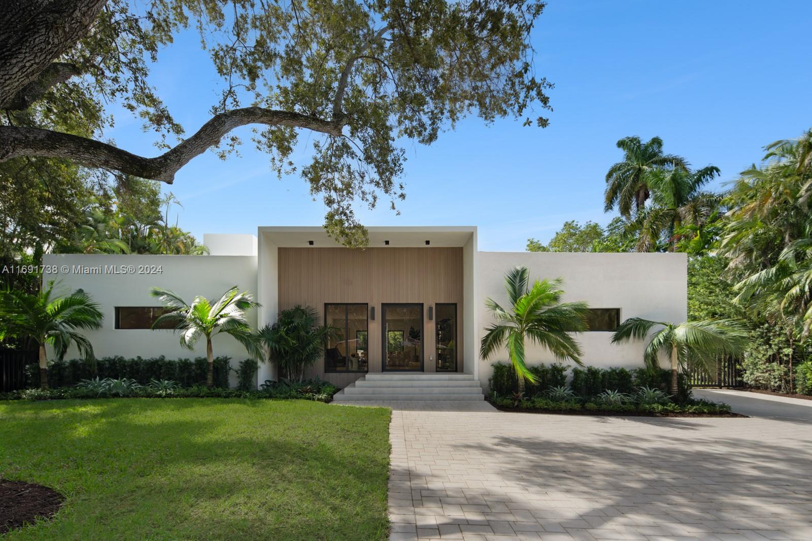 WATERFRONT BRAND NEW CONSTRUCTION STEPS FROM MIAMI COUNTRY DAY PRIVATE SCHOOL.  A TROPICAL LUXURY ESTATE ON 20K+ LOT METICULOUSLY DESIGNED BY WORLD RENOWNED ARCHITECT KOBI KARP.  SEAMLESS INDOOR/OUTDOOR LIVING ENCOMPASSING 5,775 SF 5 BEDROOMS PLUS OFFICE/DEN + 5 FULL BATH AND 2 HALF BATHS.  MILLWORK BY ITALKRAFT WITH STUNNING MASTER CLOSET WITH GLASS DOOR SHOWCASES AND LED LIGHTING.  OVERSIZED KITCHEN ISLAND WITH ALL GAGGENAU APPLIANCES INFINITY EDGE POOL + JACUZZI WITH CABANA BATH AND OUTDOOR SHOWER OVERLOOKING THE TRANQUIL 100 FT OF CANAL FRONTAGE WITH DUCKS AND TURTLES.  TWO LARGE PRIMARY SUITES AND SECOND FLOOR BALCONY WITH BOOK MATCHED STONE IN BATHROOMS.  DRAMATIC CEILING HEIGHTS THROUGHOUT WITH VAST LIVING AREAS.  EXPERT LANDSCAPING WITH IRRIGATION SYSTEM AND EXPANSIVE DRIVEWAY.