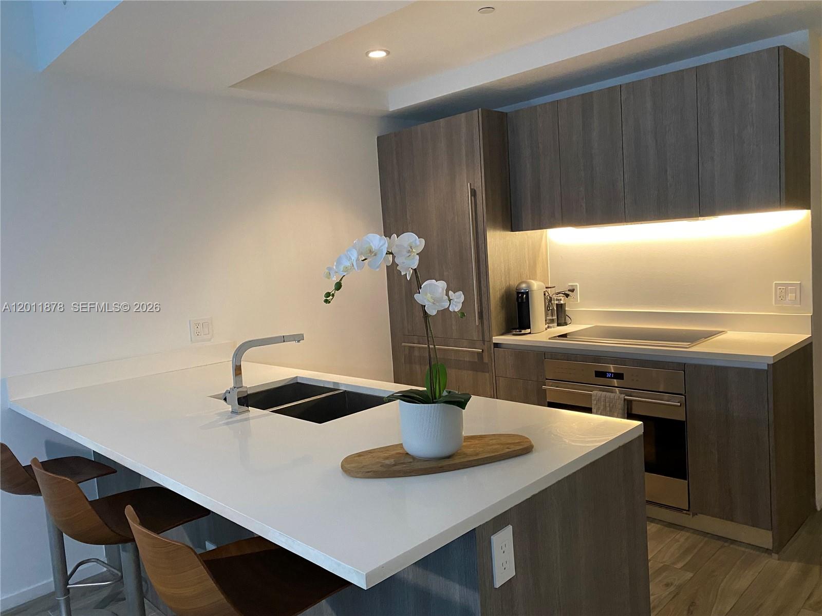 Experience elevated urban living in Residence 2306 at SLS Lux, one of Brickell’s most sought-after luxury addresses. This beautifully appointed 1-bedroom + den, 2-bathroom residence offers a smart split layout with floor-to-ceiling glass, abundant natural light, and stunning city skyline views. The spacious den is ideal as a home office, guest space, or flexible second sleeping area. The sleek Italian kitchen features premium Wolf and Sub-Zero appliances, quartz countertops, and custom cabinetry, perfectly blending style and functionality. The primary suite offers generous closet space and a spa-inspired bathroom with dual vanities, a soaking tub, and a glass-enclosed shower. A second full bathroom adds convenience for guests and everyday living. Enjoy a large private terrace perfect for morning coffee or evening entertaining. SLS Lux offers world-class amenities including resort-style pool, full-service spa, state-of-the-art fitness center, tennis court, rooftop lounge, concierge, valet, and exclusive resident services. Located in the heart of Brickell, just steps from fine dining, luxury shopping, Brickell City Centre, Mary Brickell Village, and Miami’s vibrant financial district. Ideal as a primary residence, second home, or investment opportunity in one of Miami’s premier luxury towers.