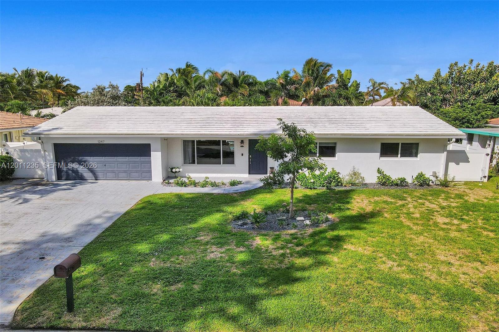 Completely renovated and move-in ready, this stunning 3-bedroom, 2-bathroom single-story home is located in the highly sought-after Cove neighborhood. Featuring full hurricane impact glass throughout, this property offers both style and peace of mind.

Step inside to discover a bright, open floor plan enhanced by beautiful wood flooring, elegant marble countertops, and top-of-the-line appliances. The spacious primary suite is a true retreat, complete with a luxurious steam shower in the master bath. 
The home also includes a thoughtfully converted garage, currently used as a 4th bedroom—ideal for guests, a home office, or additional living space. It can easily be converted back to a traditional garage if desired.

Step outside to your own private oasis featuring a stunning pool and an inviting fenced backyard with plenty of space for outdoor seating and entertaining—perfect for enjoying the South Florida lifestyle year-round.

Ideally situated just minutes from the Intracoastal Waterway and the Atlantic Ocean, this home provides convenient access to beaches, dining, shopping, and everything you need.