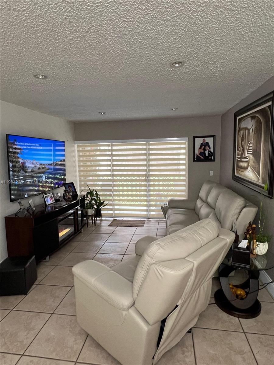 Rare opportunity in Los Arboles Condominium! This spacious 3-bedroom, 2-bathroom first-floor unit offers 1,260 sq ft of living area, a layout that is rarely available in the community. The property features modern finishes with tile flooring throughout, an updated kitchen with stainless steel appliances, and a bright open living and dining area. Enjoy a private terrace, perfect for relaxing or entertaining. The unit includes two assigned parking spaces, adding extra convenience for owners or tenants. Currently occupied by a long-term excellent tenant, making it a great opportunity for both investors and end users. Ideally located in the heart of Hialeah, close to major highways, shopping, restaurants, and everyday conveniences. WATER is included on the HOA, 40year inspection pass 2023 no assessment & condo have reserve