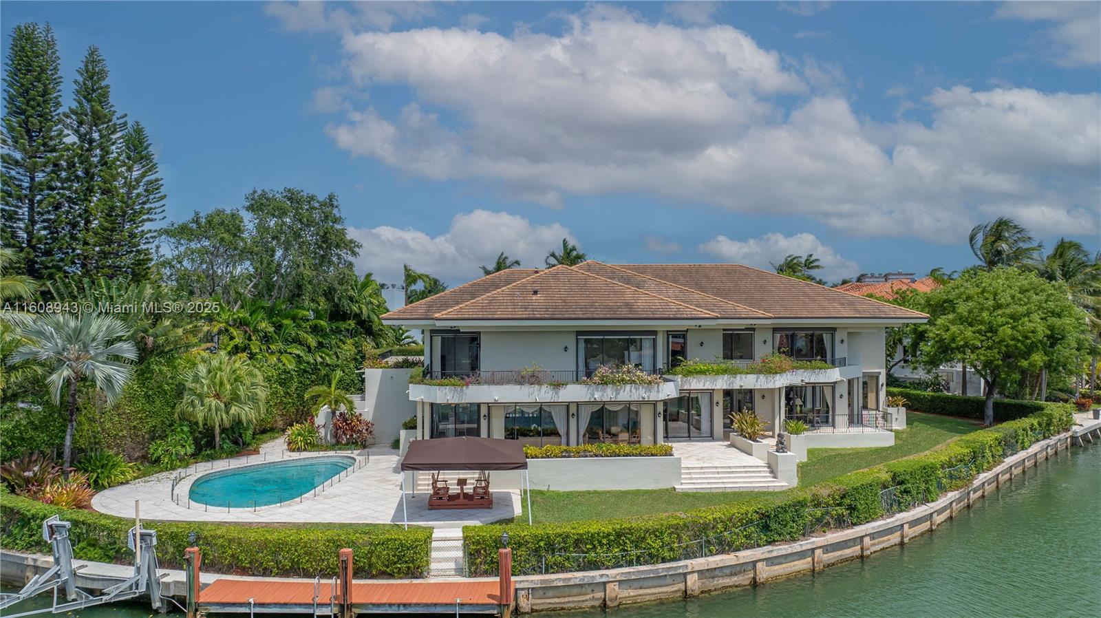 Spectacular contemporary estate set on a coveted cul-de-sac along Cape Florida Dr., one of Key Biscayne’s most prestigious and private addresses. Situated on a 23,724 sqft lot with +250 ft of waterfront and elevation of 8.71 ft above sea level, this home offers 8 bedrooms (including a guest suite and 2 staff quarters), 8.5 baths, a private dock, boat lift, and resort-style pool. A grand foyer with soaring ceilings introduces an architectural masterpiece designed by renowned architects and built by Interscope. More features include an elevator, full-home generator, reinforced concrete seawall, 2-car garage + porte-cochere for 4 cars, and driveway for 8+ cars. Discover the exceptional potential of this unique estate—a perfect blend of elegance, privacy, and premier waterfront living.