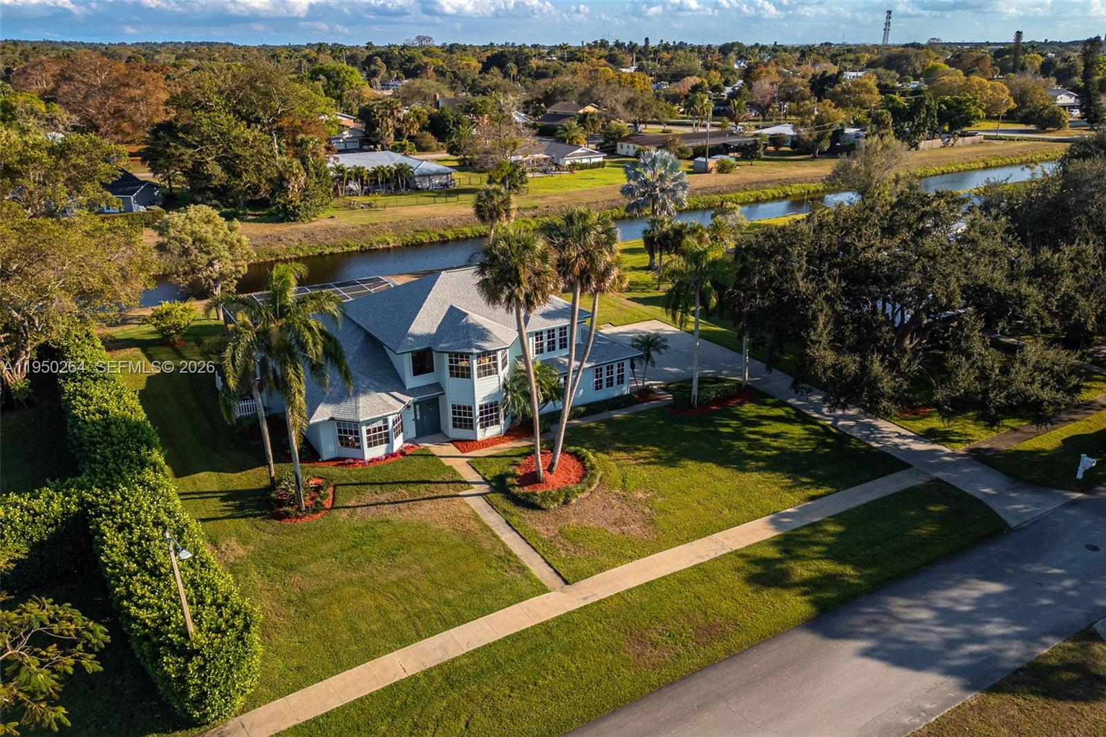 Nestled in one of Clewiston's most sought-after neighborhoods, this impressive residence delivers nearly 3,700 sq ft of thoughtfully designed living space with 4 bedrooms, 3 full baths, and 2 half baths, all beneath a brand-new roof (2025). Beautiful landscaping welcomes your home, while soaring ceilings, an open layout, and new flooring throughout the kitchen and main hall set an elegant tone inside. The family room elevates the experience further with built-in surround-sound speakers and a striking wood accent wall. The primary suite serves as a true retreat with tray ceilings, a double-sink bathroom, a dedicated vanity, two walk-in closets. Outside, a resort-style pool resurfaced in 2021, complete with a newer heater, pump, and a brand-new pool cage (2023), complemented by a steam room, outdoor shower, and poolside half bath for the ultimate backyard oasis. Additional highlights include two new AC units (2024 & 2025), an irrigation system with a new pump (2023), a 2-car garage, a second-floor laundry chute, and access to a nearby neighborhood playground, making this home as practical as it is impressive. The sellers are willing to sell the furniture with the home, providing a true turnkey opportunity!