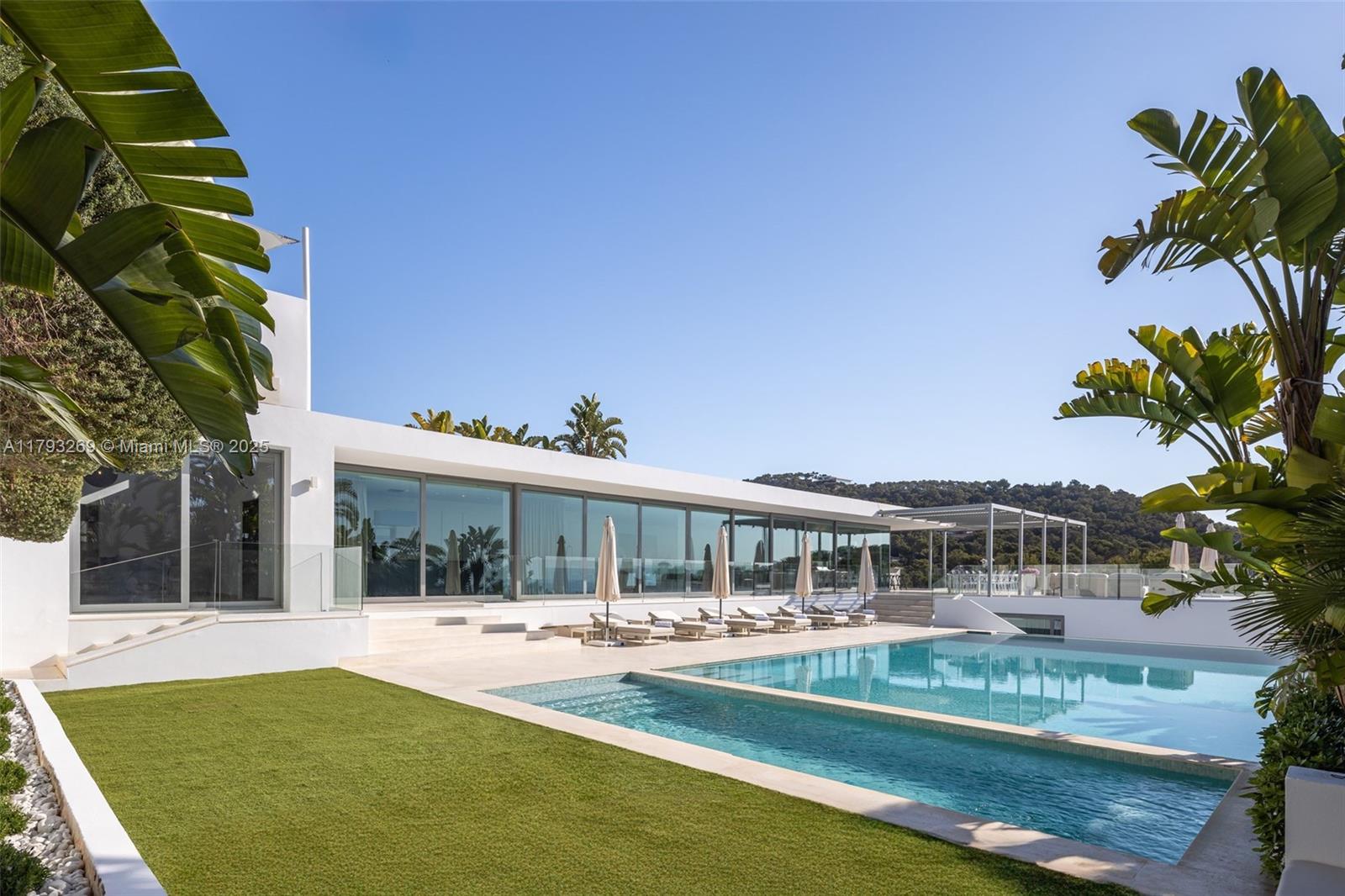 This marvellous property is truly breathtaking. Designed by world renowned architect Bruno Erpicum to capture the vibrancy, fun and natural beauty of Ibiza, not only will you be staying in a piece of iconic architecture but you’ll also be able to take advantage of one of the most luxurious locations on the island.
You’ll also experience possibly the best views on the island; wake up in this villa and you’ll be met by an unparalleled panorama – sun soaked vistas of the Mediterranean and island of Formentera.
Hidden within pine trees and fragrant gardens, this 850-square-metre (9,150-square-foot) on top of a plot of land of 1600m2, 8-bedroom villa opens to expansive outdoor terraces and gardens, including a private pool and Jacuzzi with views of the sea.