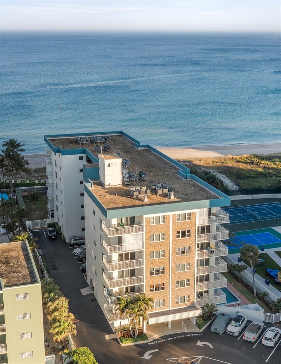 Follow an open air breezeway to this beautifully remodeled 1BR/1.5BA unit with breathtaking ocean views. NEW-kitchen with quartz countertop, bathrooms, luxury vinyl flooring, a/c, water heater & washer/dryer. NEW Roof 2025. Impact glass and doors, designated parking and ample guest parking that allows trucks & motorcycles. Extra private storage in lobby. Fully funded reserves & passed 40 year certification 2025. There's only a handful of small boutique buildings like this left on the East side of A1A. HOA includes internet, cable TV, wind insurance, water, sewer & trash, pest control and on-site mgmt. Building is located between the bustling entertainment districts of Pompano Pier and Commercial Pier, and a Publix is nearby, all within short distance. Rentals allowed 3X year, 30 day min.
