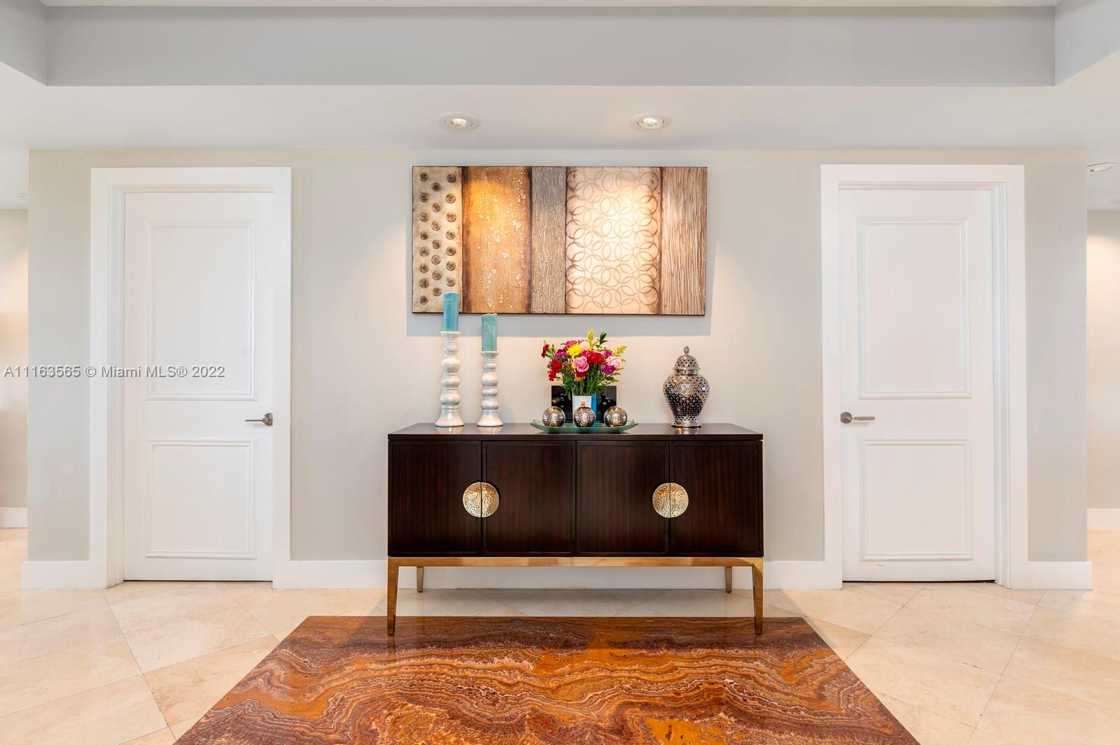 Private elevator entrance opens to this luxury oasis renovated in 2015. Natural light flows through both sides of this split floor plan 3bd/4ba flow through condo with top of the line finishes, open kitchen, with Subzero and GE Monogram appliances, walnut and marble flooring and renovated bathrooms in all the bedrooms. Master suite has a spa like bathroom and expansive balcony with ocean view.  Prestigious Ocean Club offers direct beach access and service, 24 hour security, pool, tennis, restaurant, tennis courts and more!