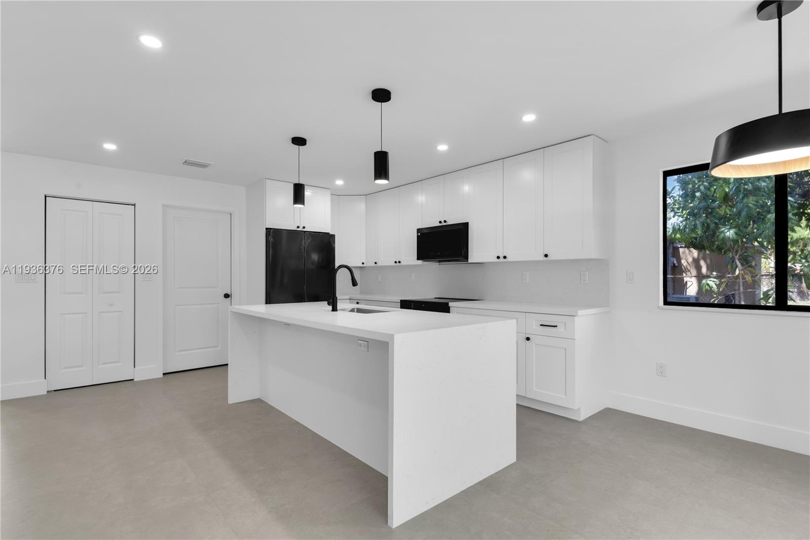 Brand-new construction 2025 4 bedroom/ 3 bath South Miami home walking distance to the University of Miami and situated within the Sunset Elementary School boundaries. This beautiful residence features a bright open-concept layout with porcelain tile flooring throughout, the home offers modern elegance and functional living. The designer kitchen showcases quartz countertops custom cabinetry, a large waterfall-edge island, sleek black fixtures, and stylish pendant lighting. Recessed LED lighting throughout enhances the clean contemporary feel.  Additional features include impact windows and doors, spacious bedrooms, custom closets and beautifully designed bathrooms. A rare opportunity to own new construction in this rapidly transforming area.